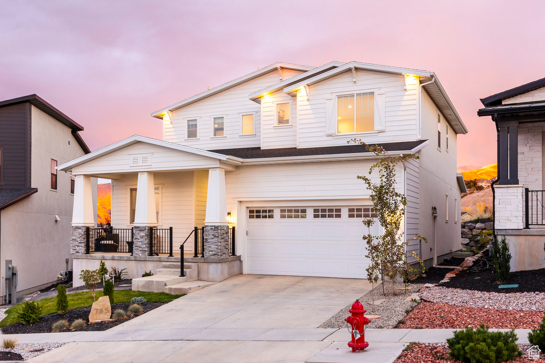 View of front of home featuring covered porch and a garage