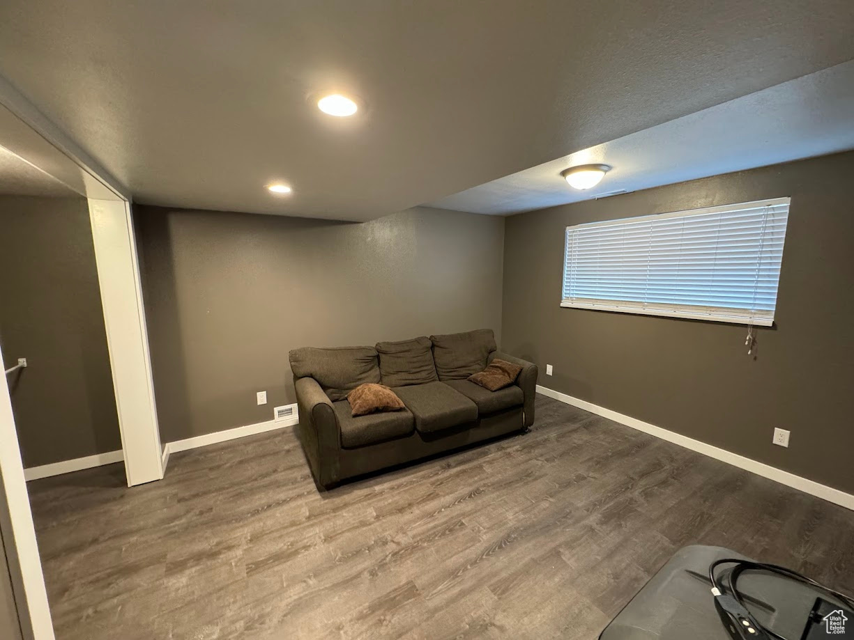 Living room featuring recessed lighting, wood finished floors, and baseboards