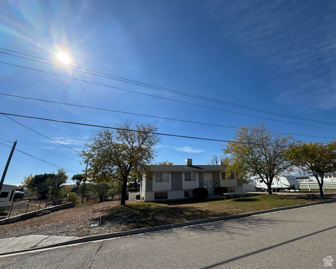 View of front of property featuring a front yard and fence