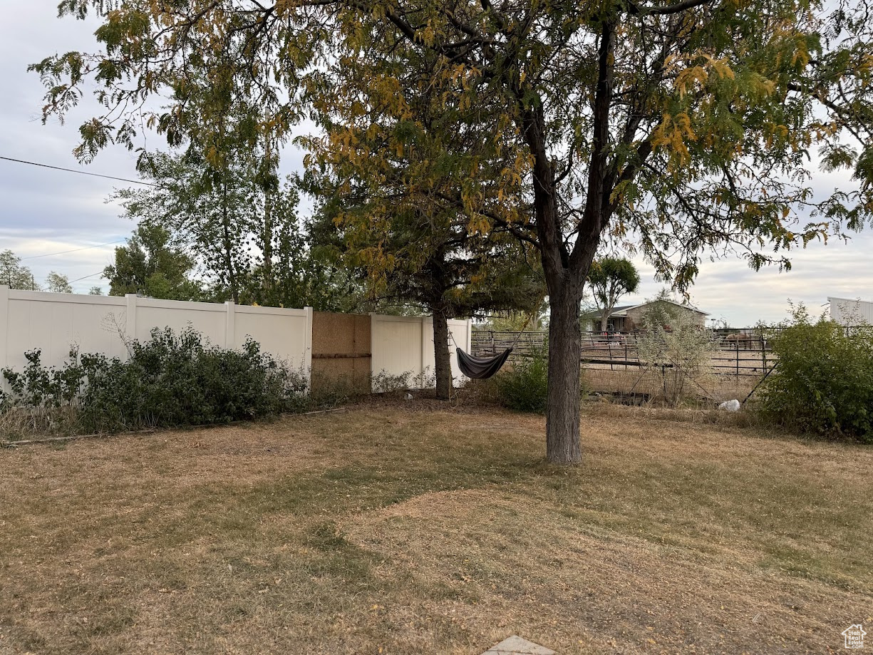 View of yard featuring fence