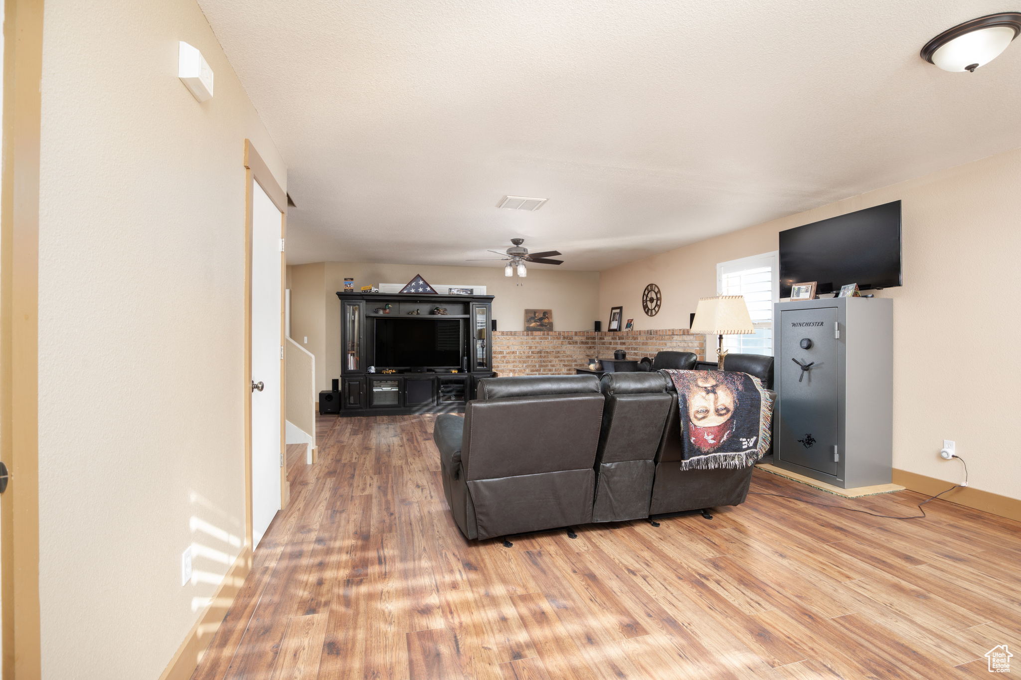 Living room featuring hardwood / wood-style flooring and ceiling fan