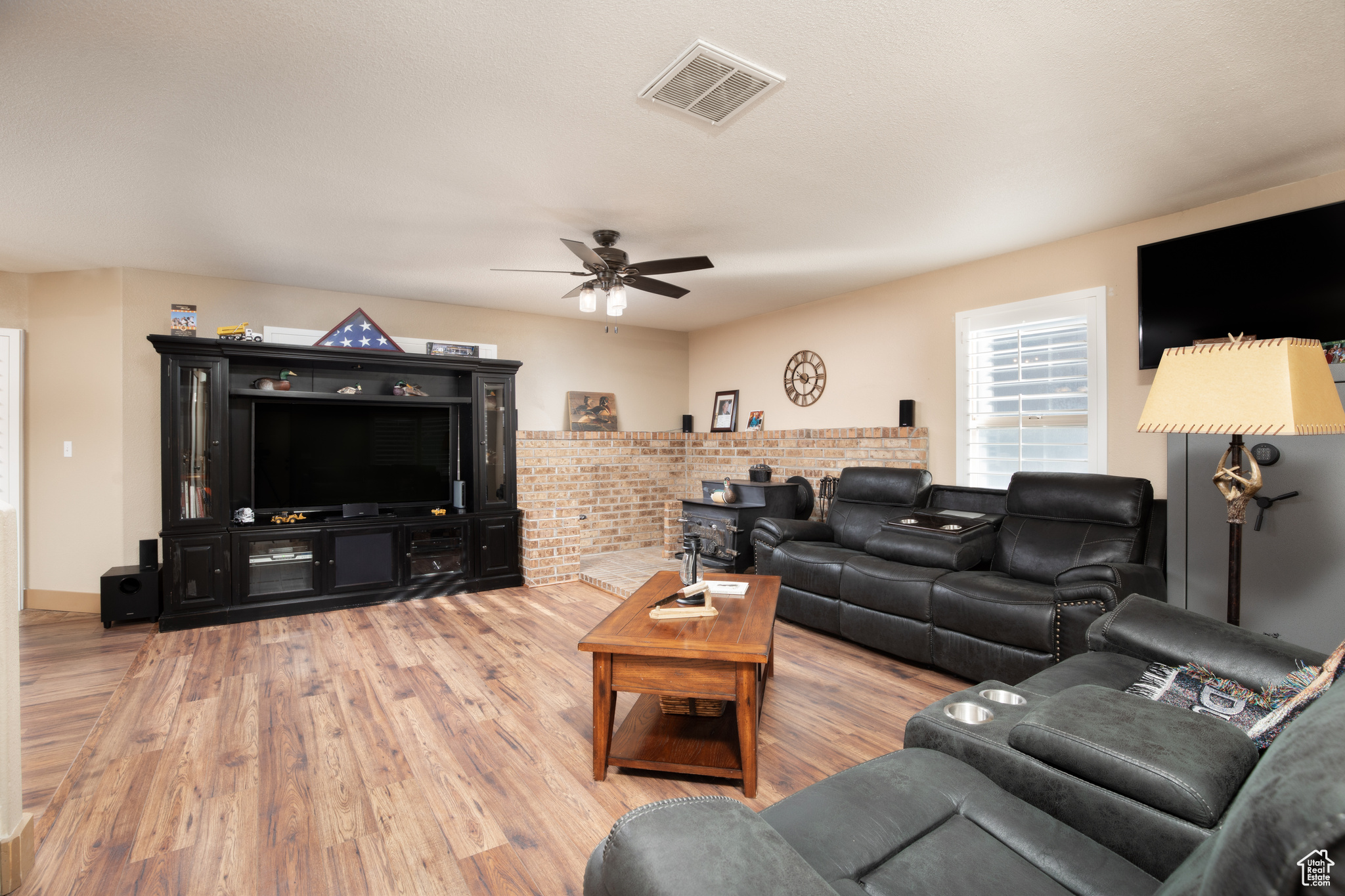 Living room with ceiling fan and light hardwood / wood-style flooring