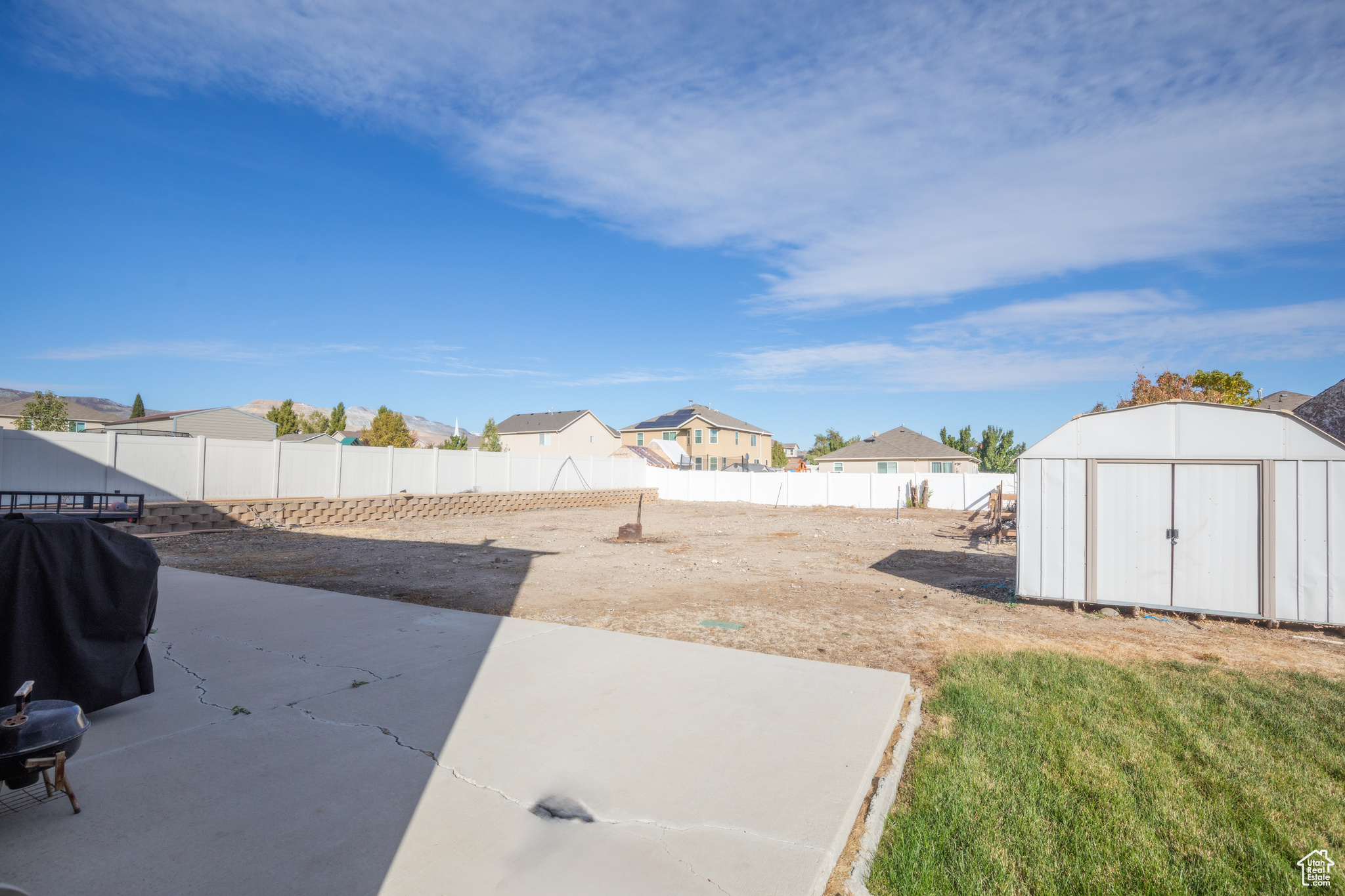 View of yard with a storage shed and a patio area