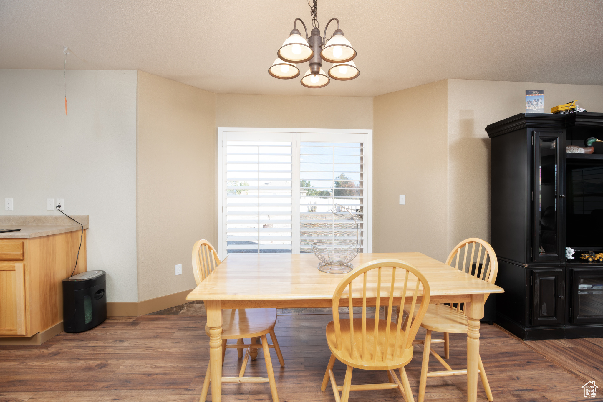 Dining room with dark hardwood / wood-style floors and a chandelier