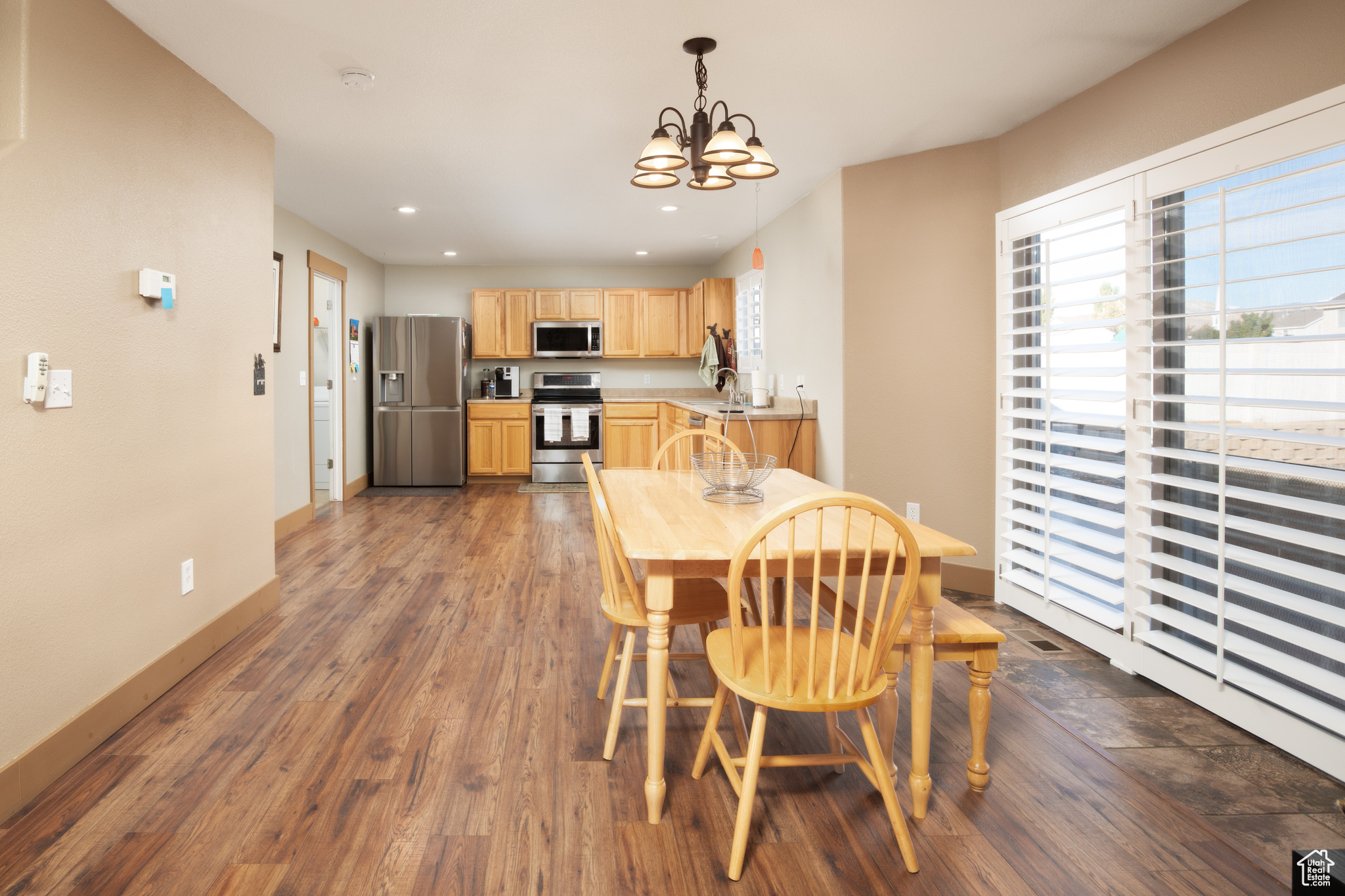 Dining room featuring dark hardwood / wood-style floors, a chandelier, and sink