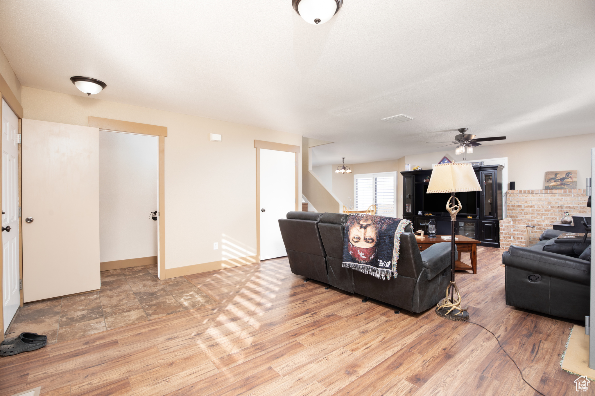 Living room with hardwood / wood-style flooring and ceiling fan