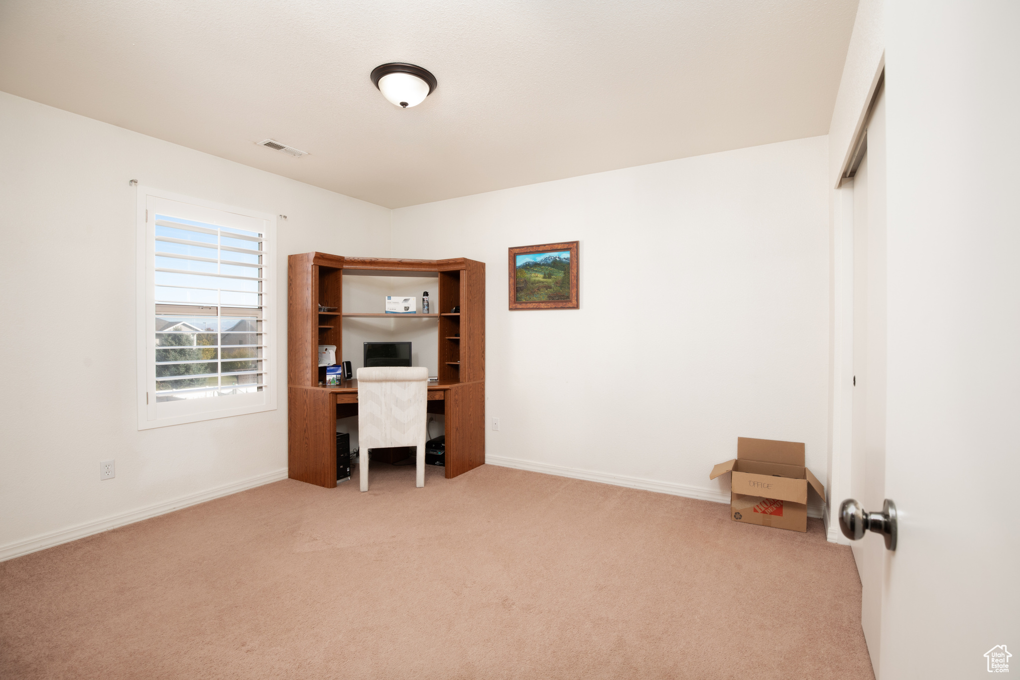 Unfurnished office with light colored carpet