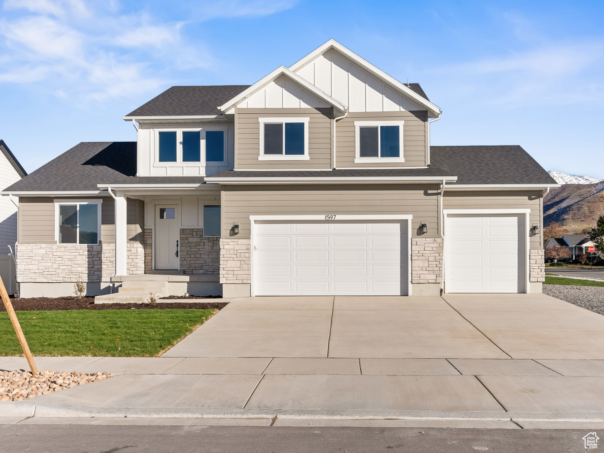 View of front of home with a mountain view and a garage