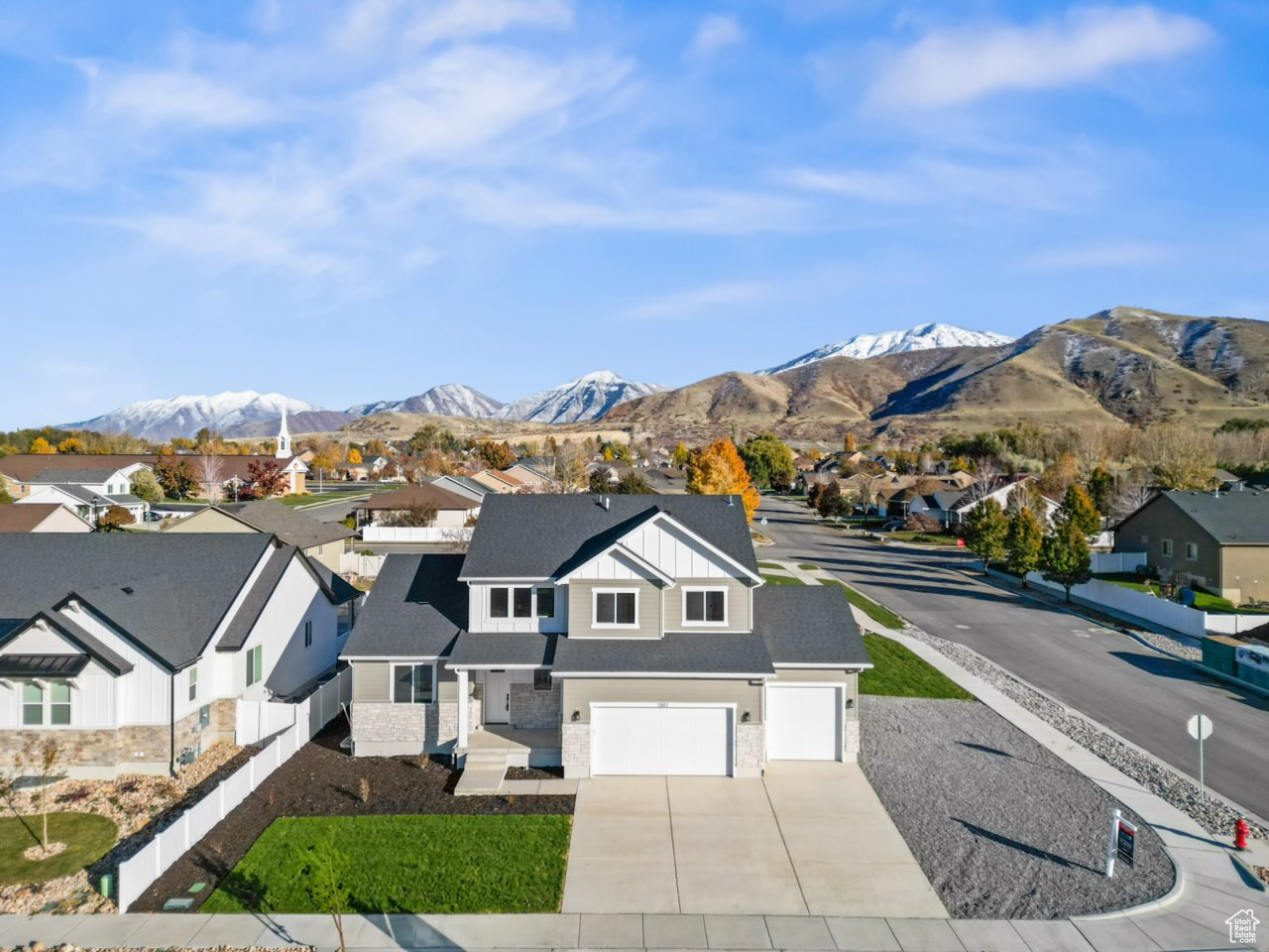 View of front of house featuring a mountain view and a garage