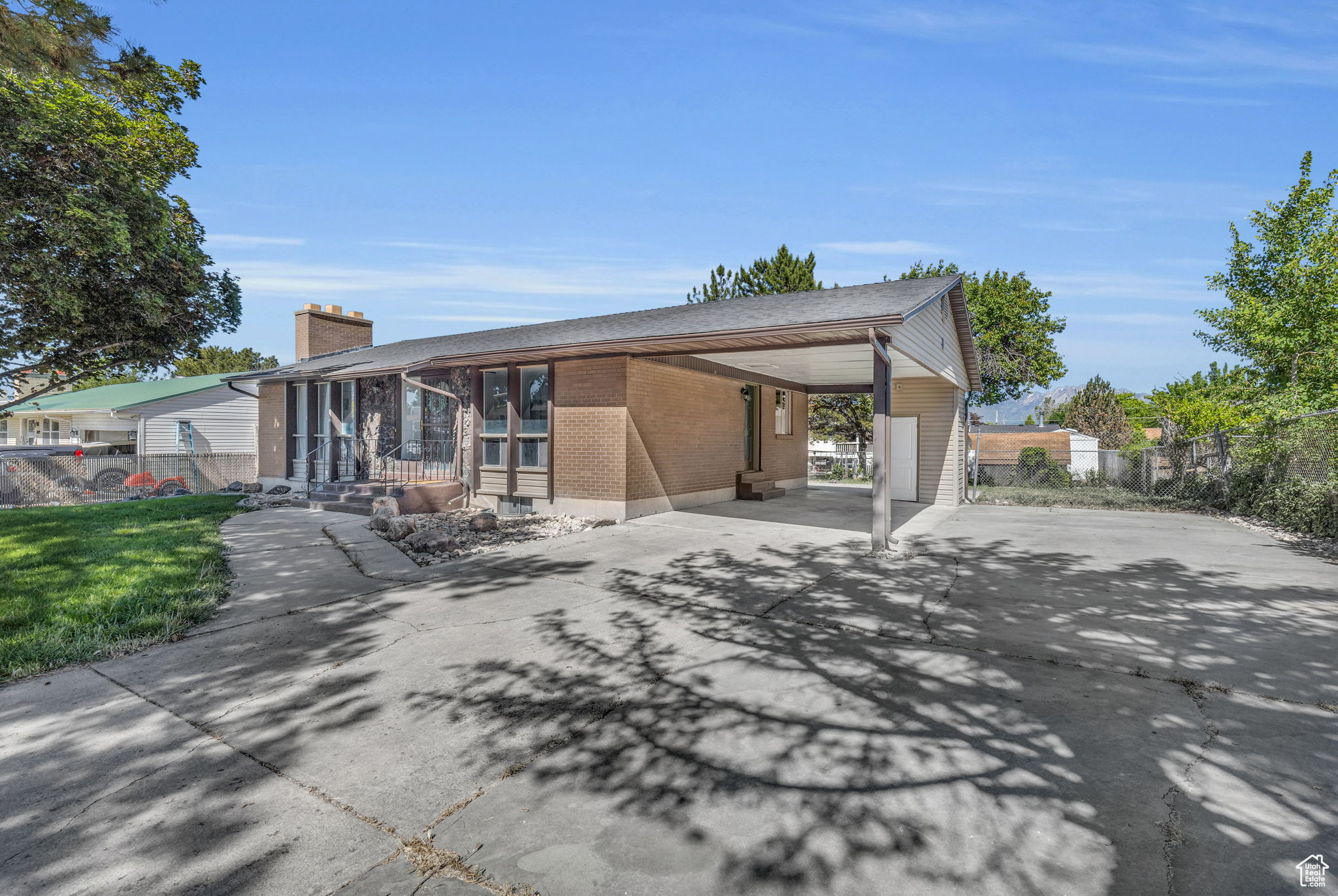 Large driveway provides ample parking with RV pad.