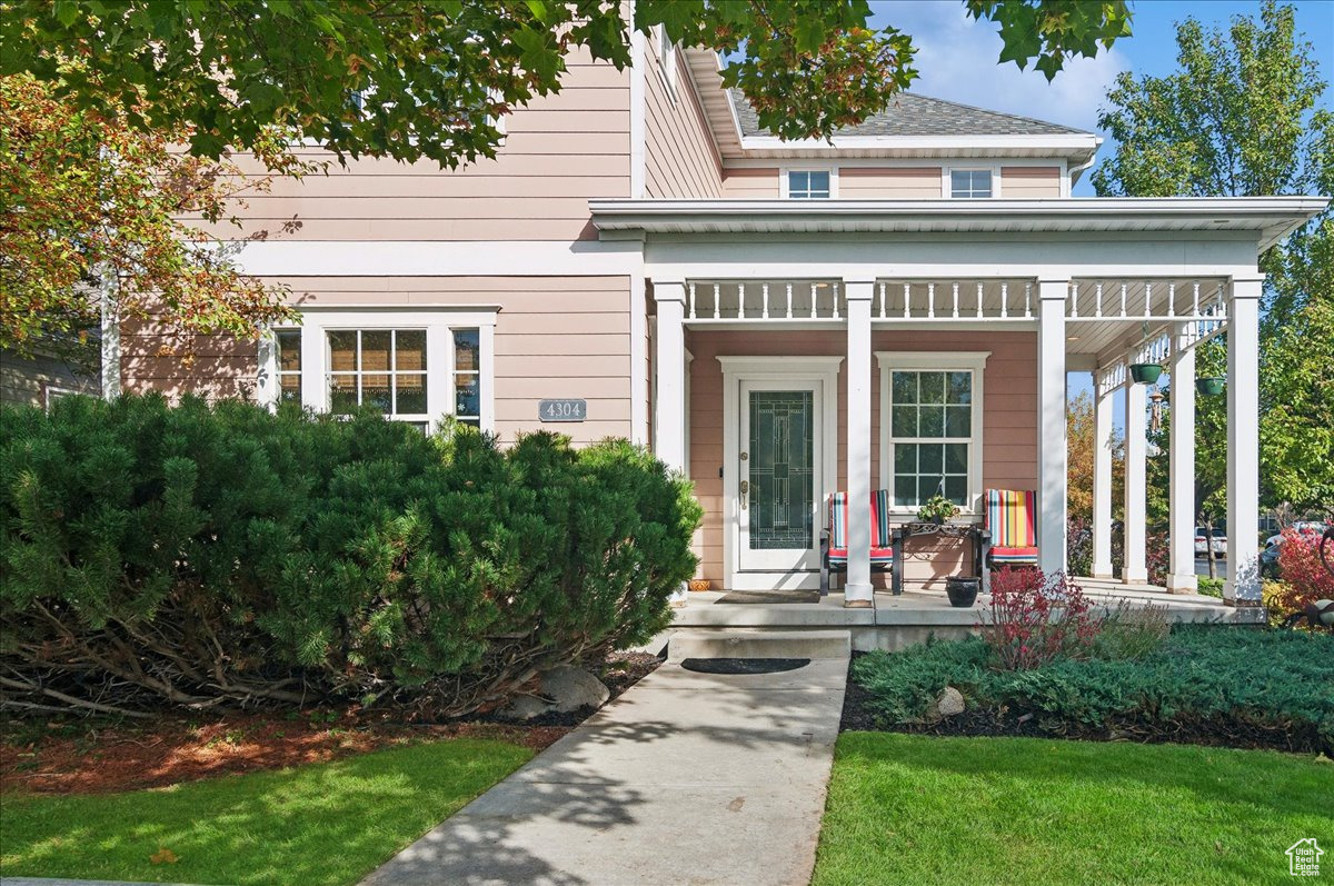 View of front of home featuring covered porch and a front lawn