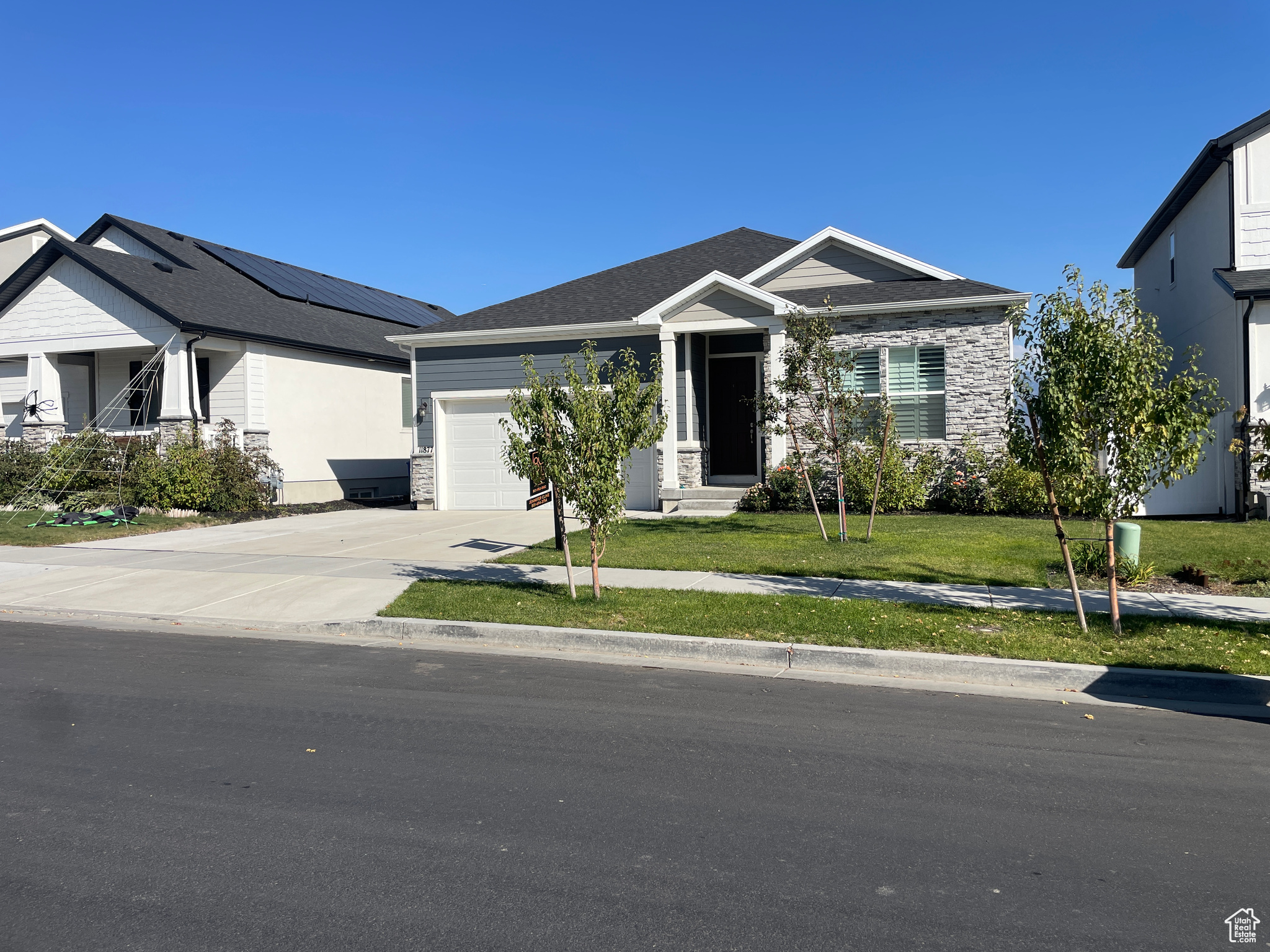 Craftsman-style house featuring a front yard and a garage