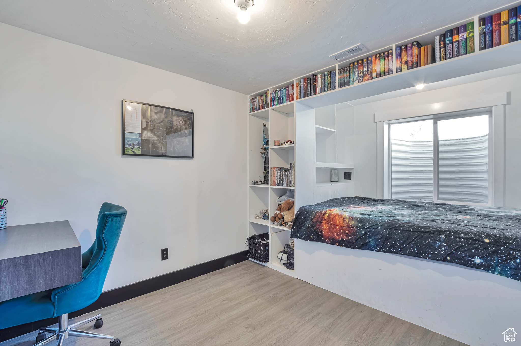 Basement bedroom with built in bed and tons of storage.