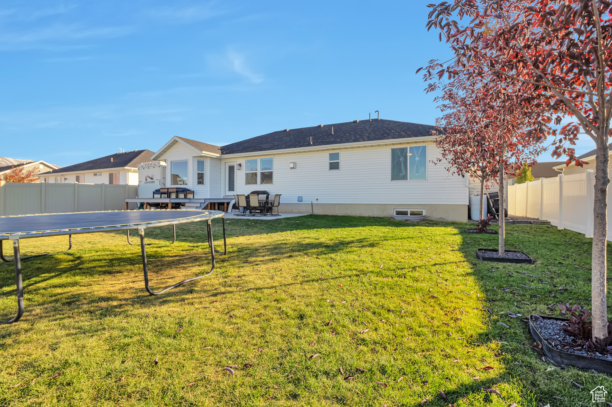 Backyard with view of deck, patio & shade trees for those summer days.