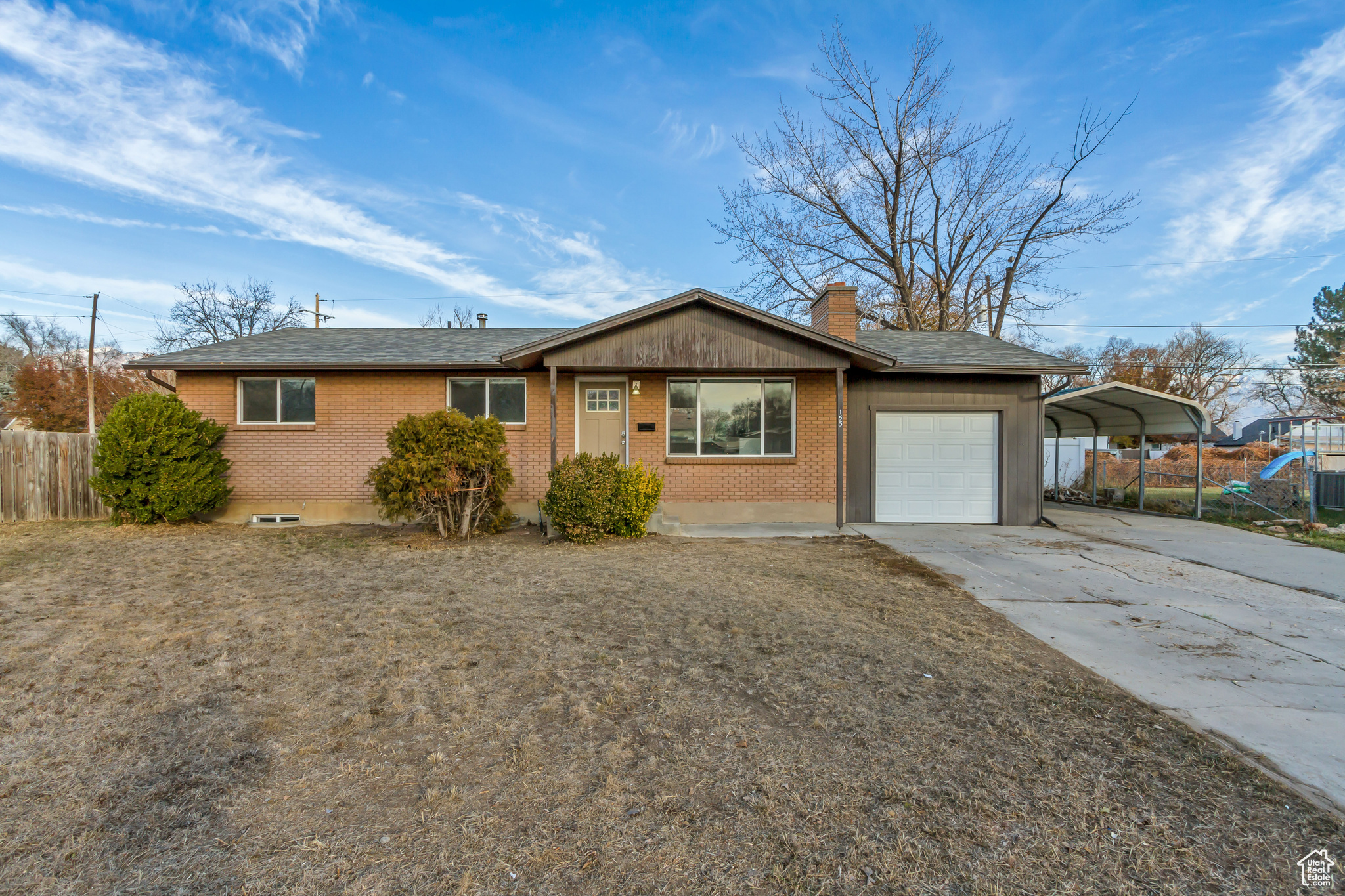 Single story home with a carport and a garage