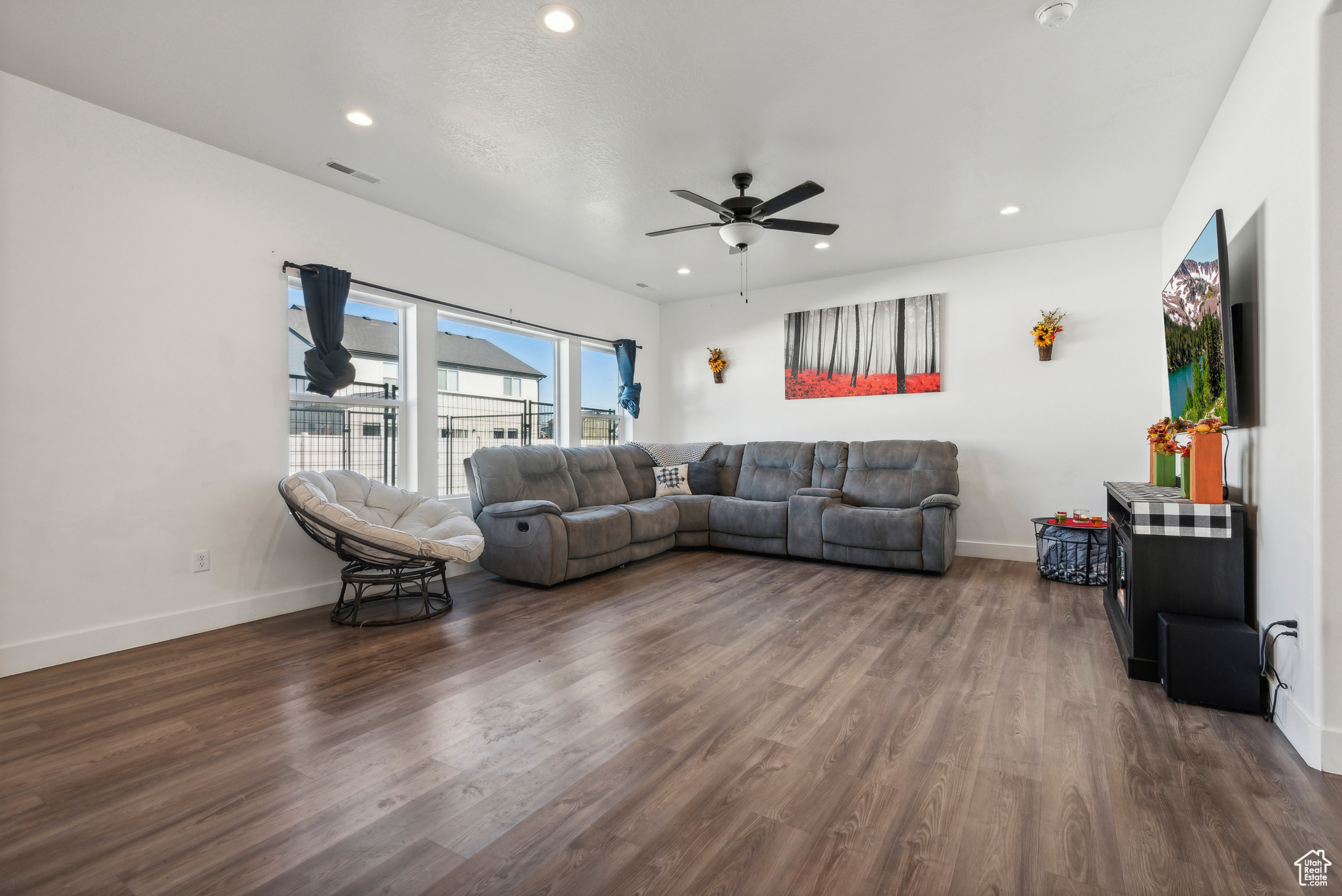 Living room featuring dark hardwood / wood-style floors and ceiling fan