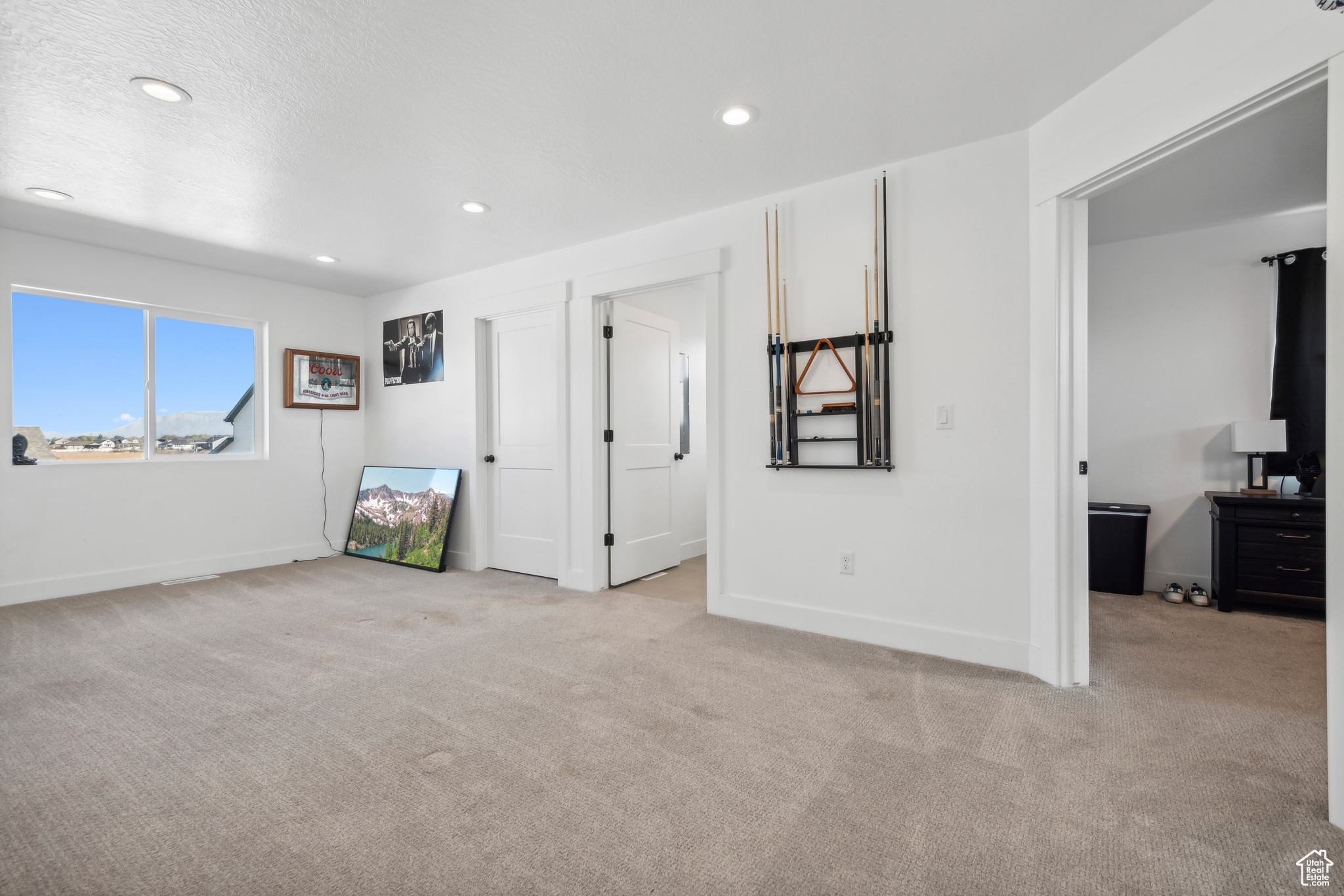 Unfurnished bedroom with light colored carpet