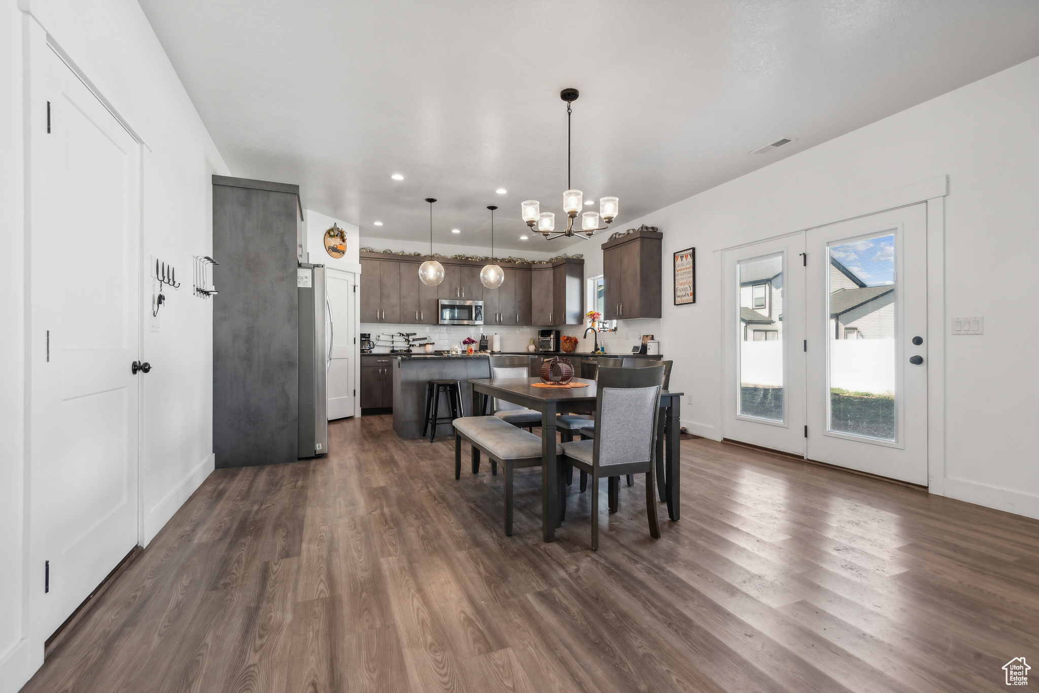 Dining room featuring dark hardwood / wood-style flooring, sink, and an inviting chandelier