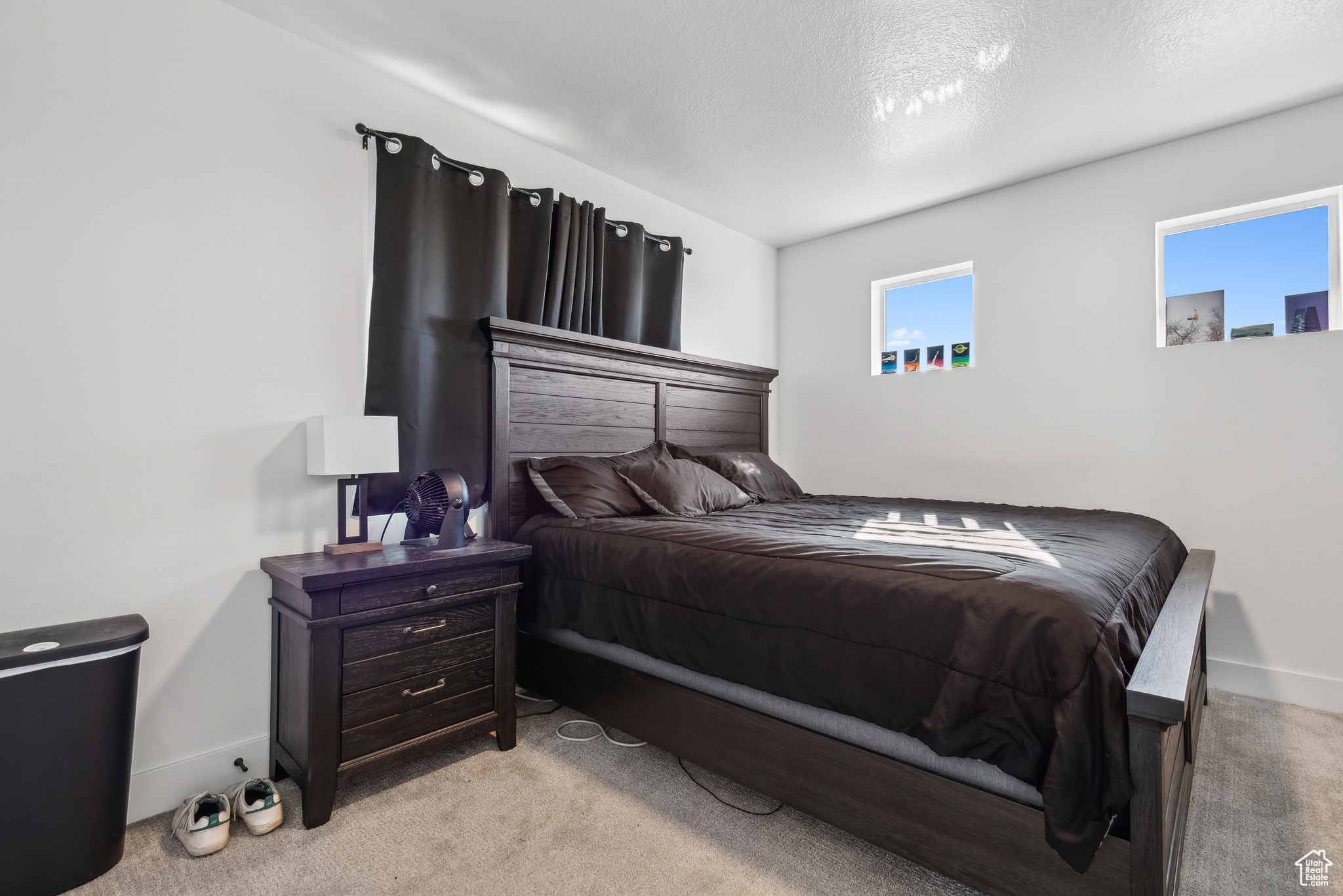 Bedroom featuring a textured ceiling and light carpet