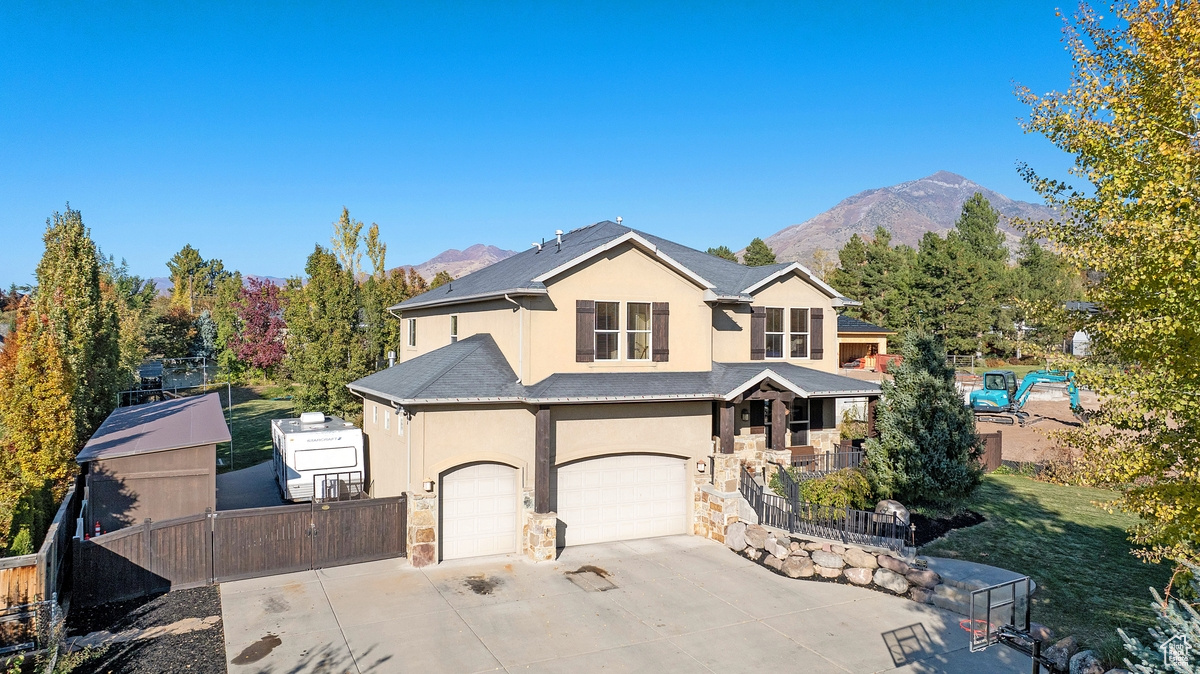 Front of property with a garage and a mountain view