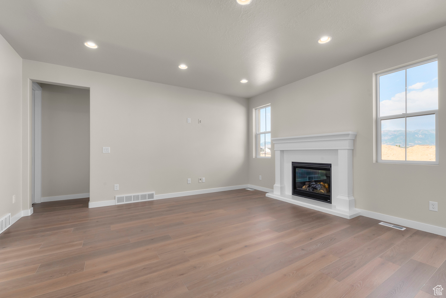 Unfurnished living room featuring hardwood / wood-style flooring