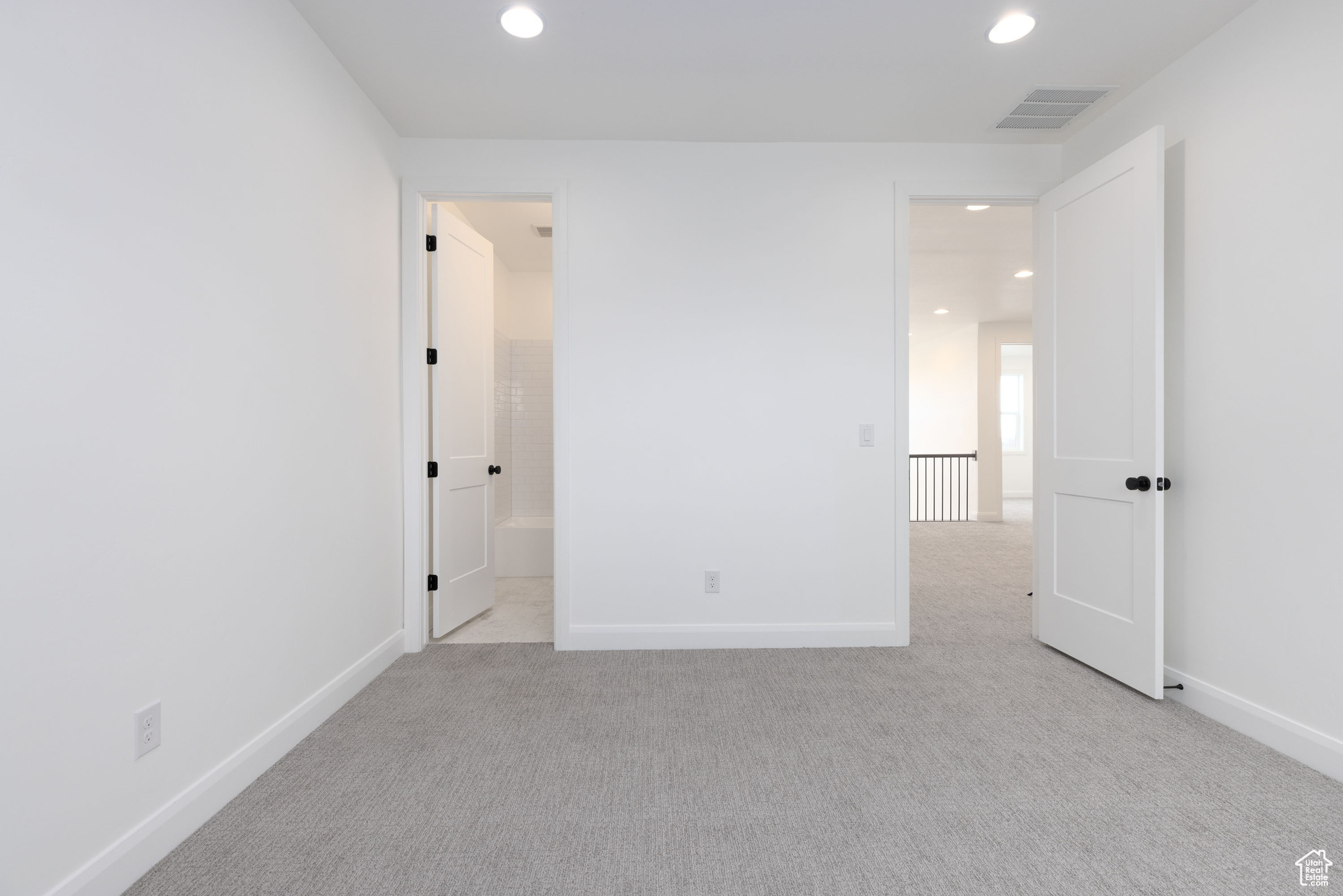 Empty room with light colored carpet