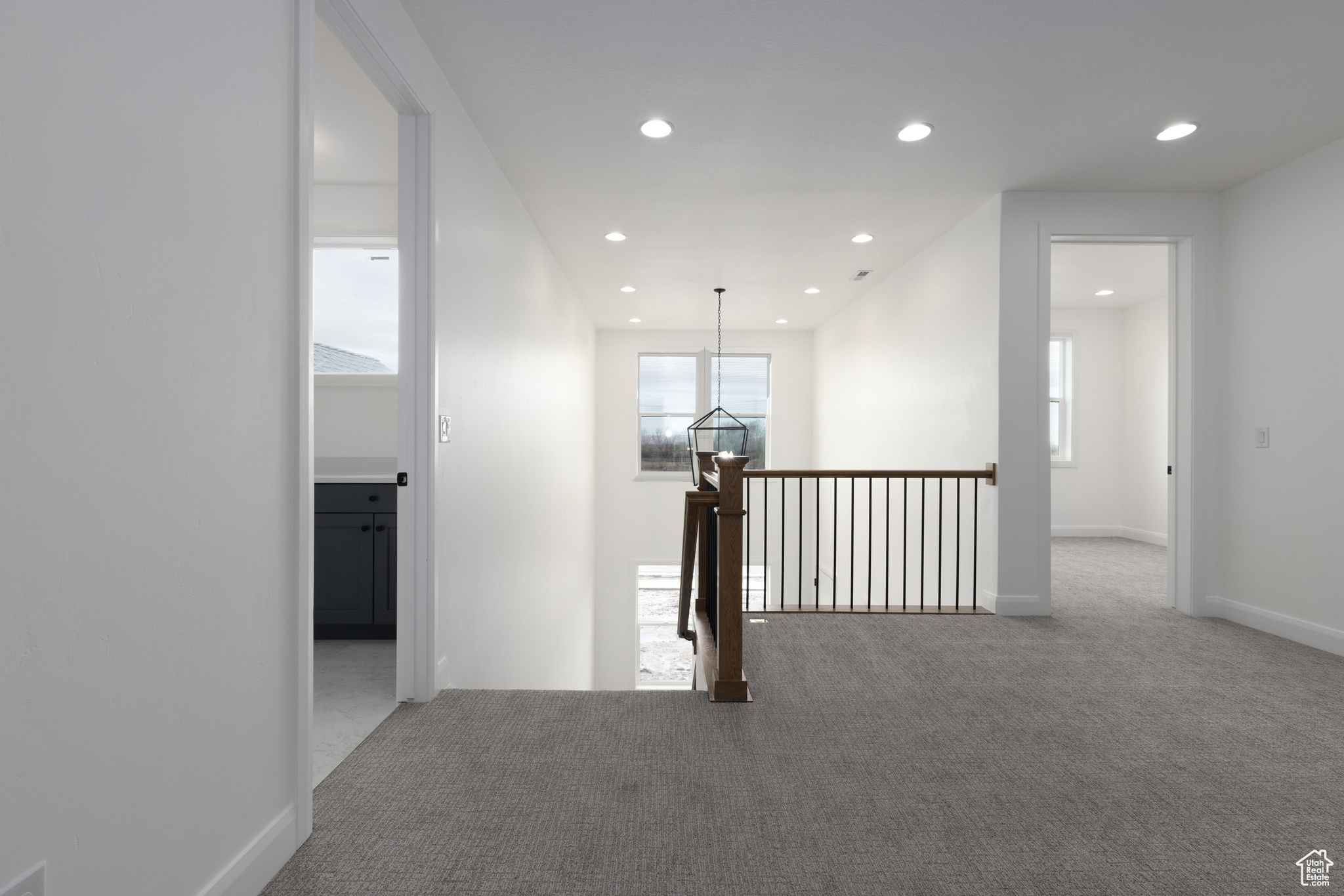 Hall featuring plenty of natural light and carpet floors