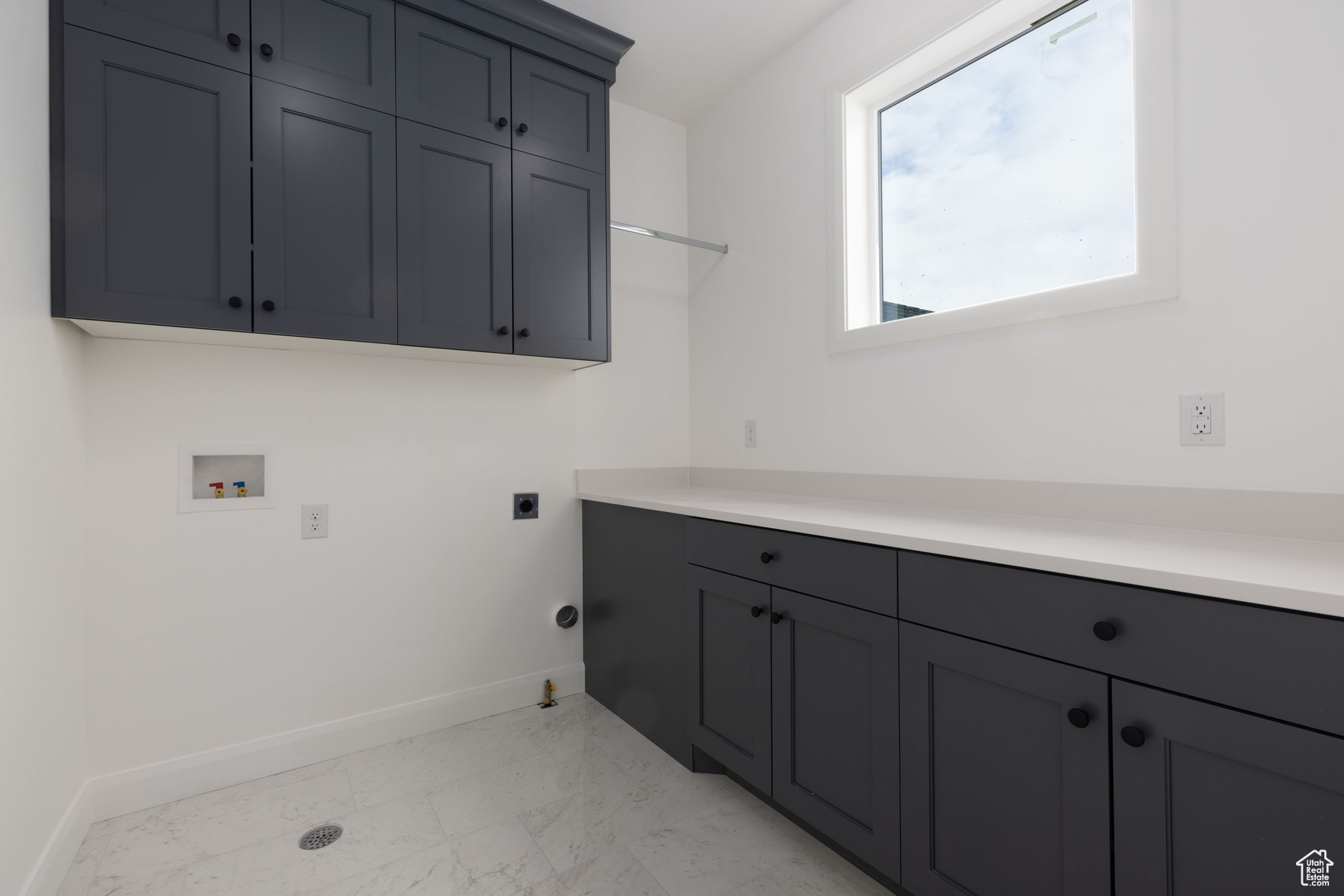 Washroom featuring cabinets, gas dryer hookup, hookup for a washing machine, and hookup for an electric dryer