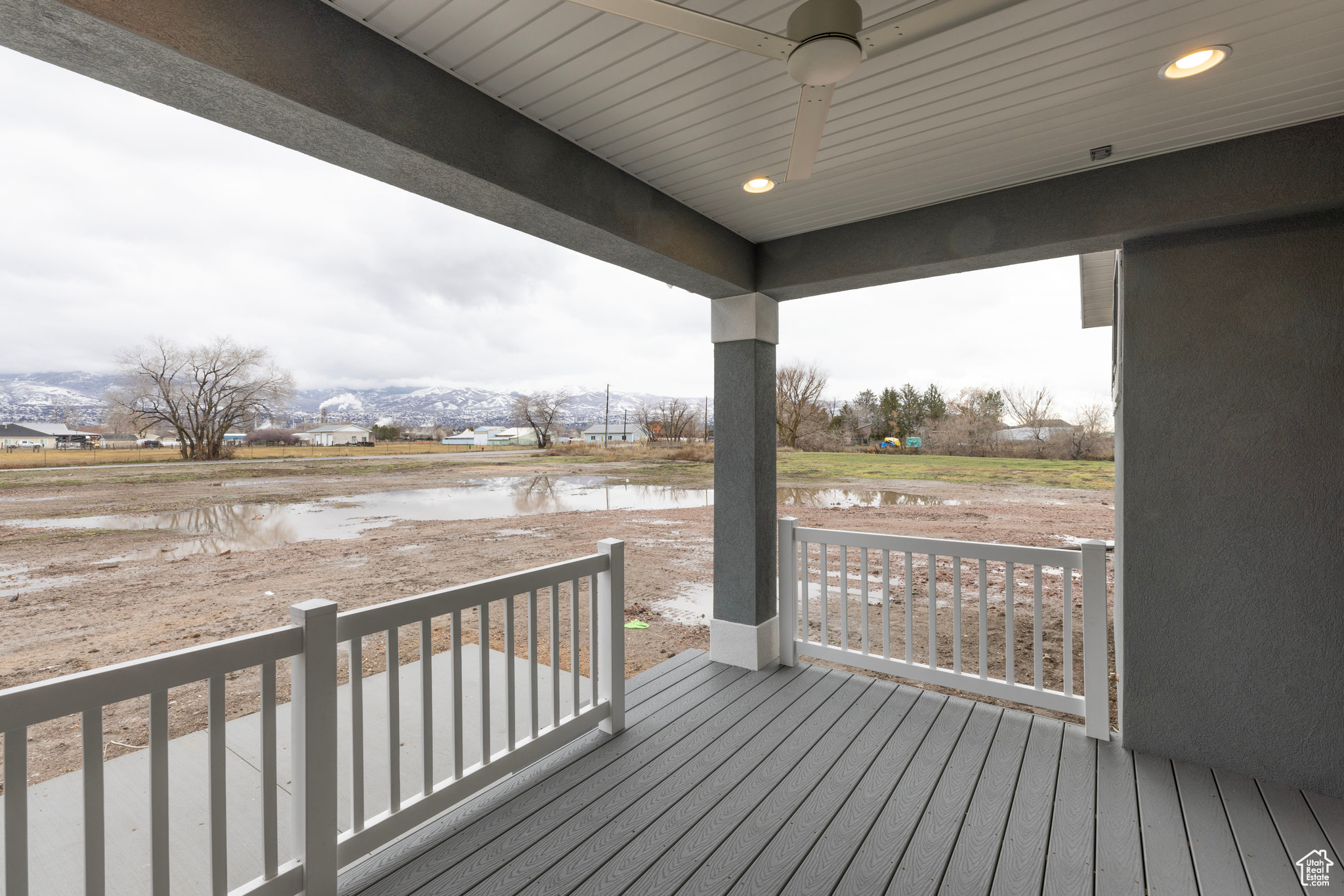 Deck featuring a water view and ceiling fan