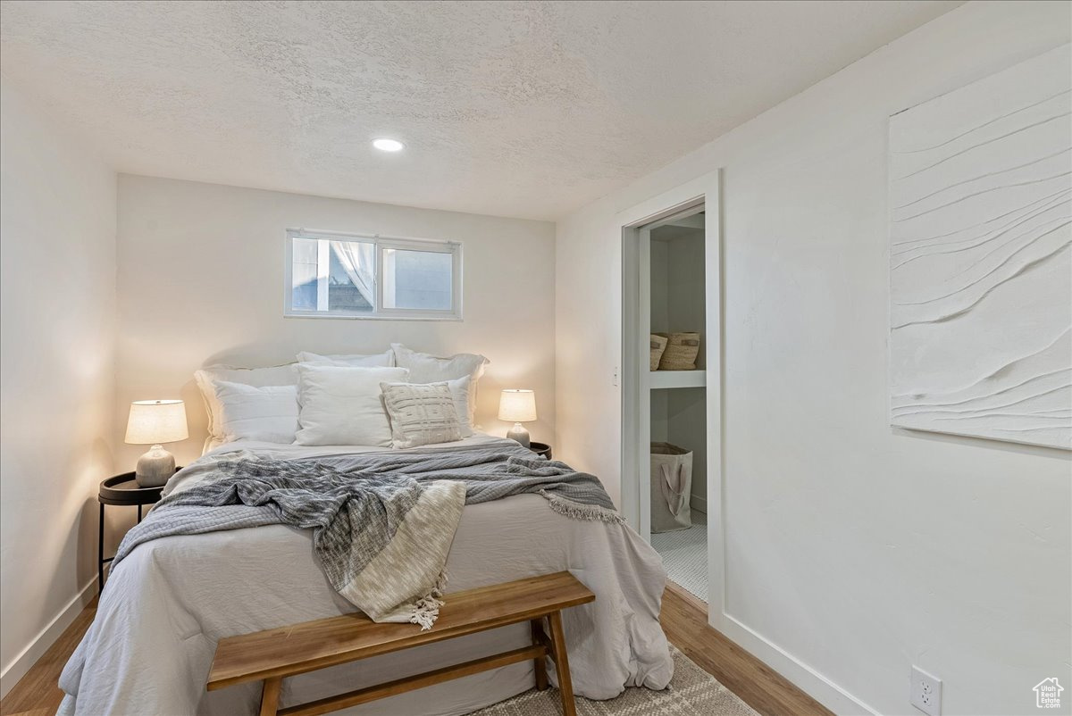 Bedroom featuring wood-type flooring and a textured ceiling