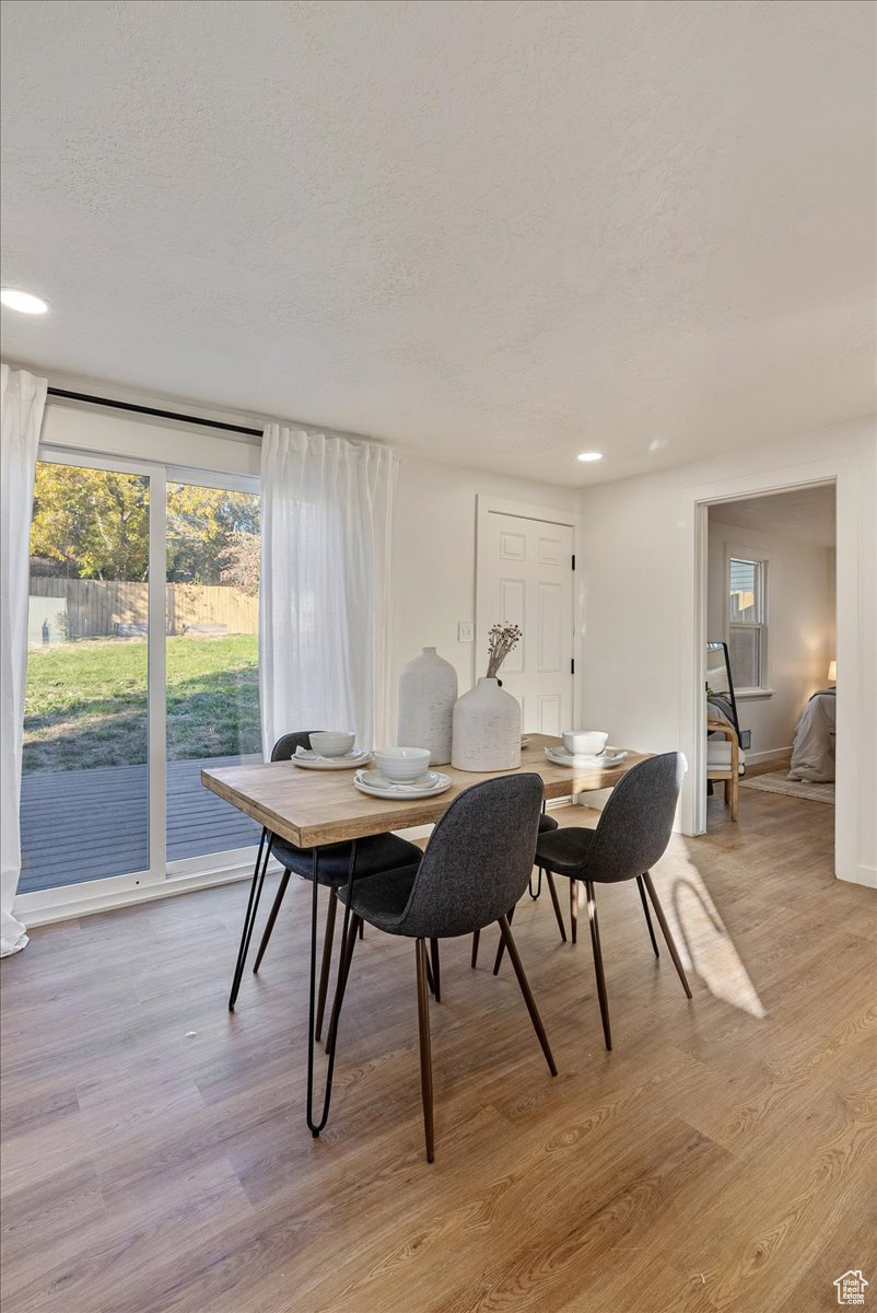 Dining room featuring a textured ceiling and light hardwood / wood-style floors