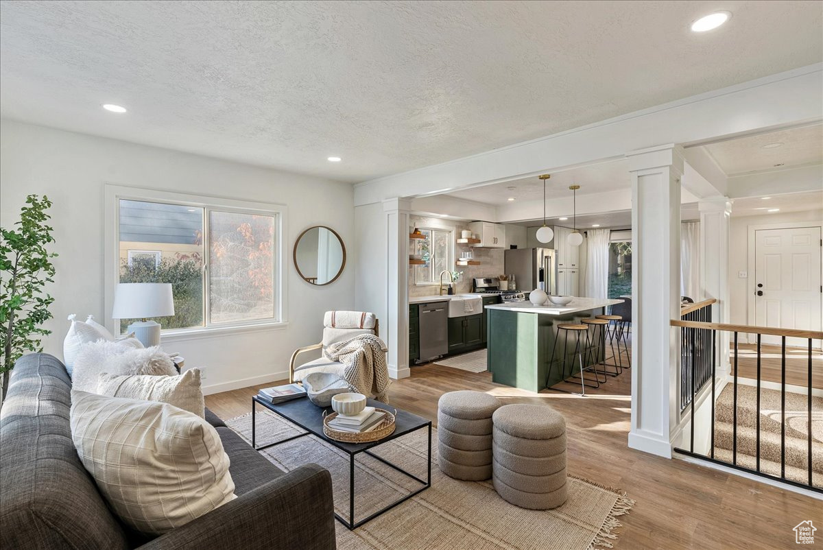 Living room featuring a textured ceiling and light wood-type flooring