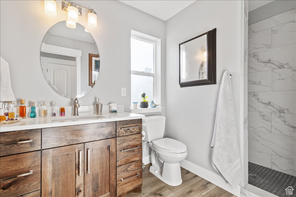 Second Main floor bathroom featuring luxury vinyl flooring high-end cabinets with quartz counter top and walkin tiled shower