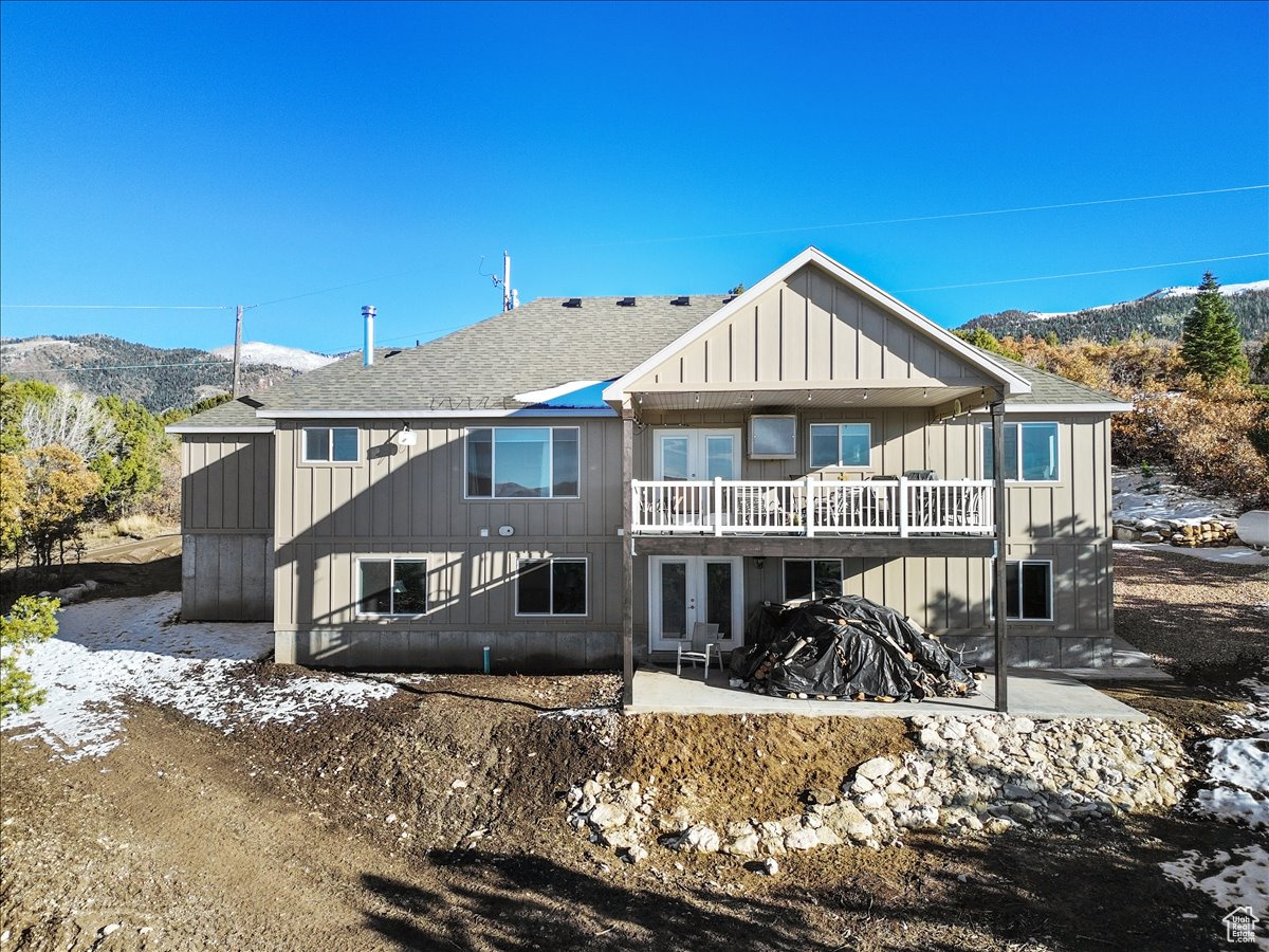 Rear view of home featuring both covered patios