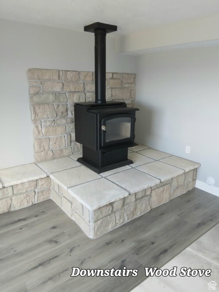 Interior details with hardwood / wood-style flooring and a wood stove