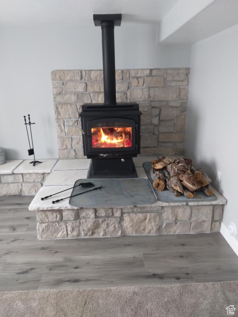 Interior details with hardwood / wood-style floors and a wood stove