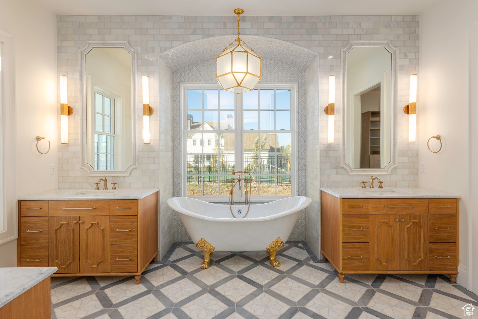 Bathroom featuring vanity, a bath, and tile walls