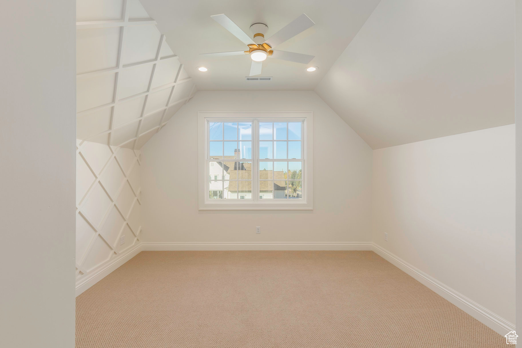 Additional living space with carpet flooring, ceiling fan, and vaulted ceiling