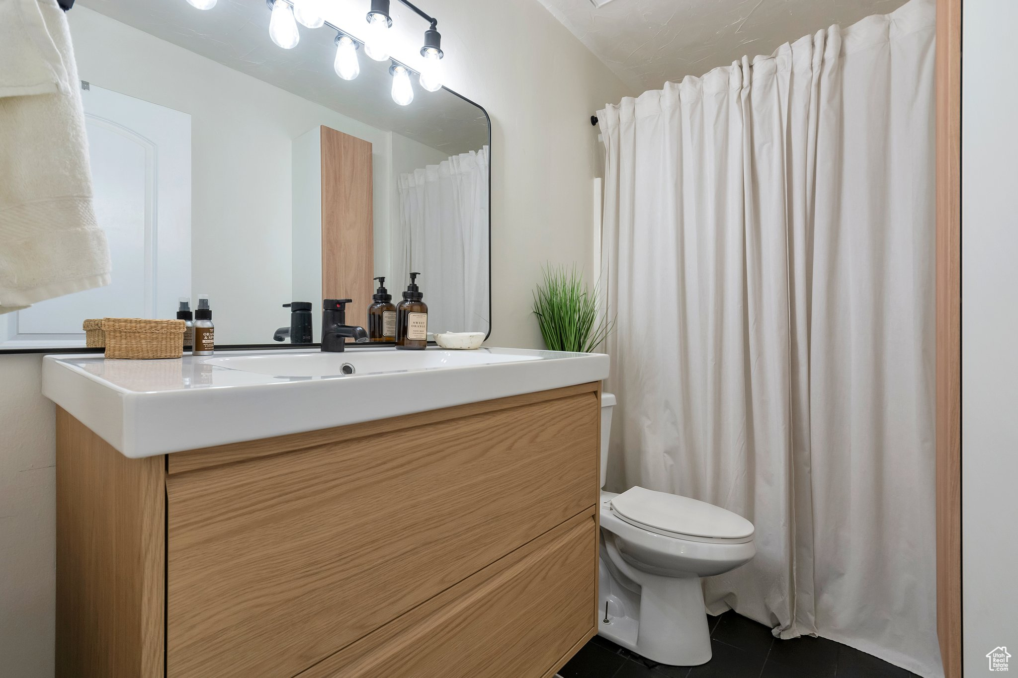 Bathroom with vanity, tile patterned floors, and toilet