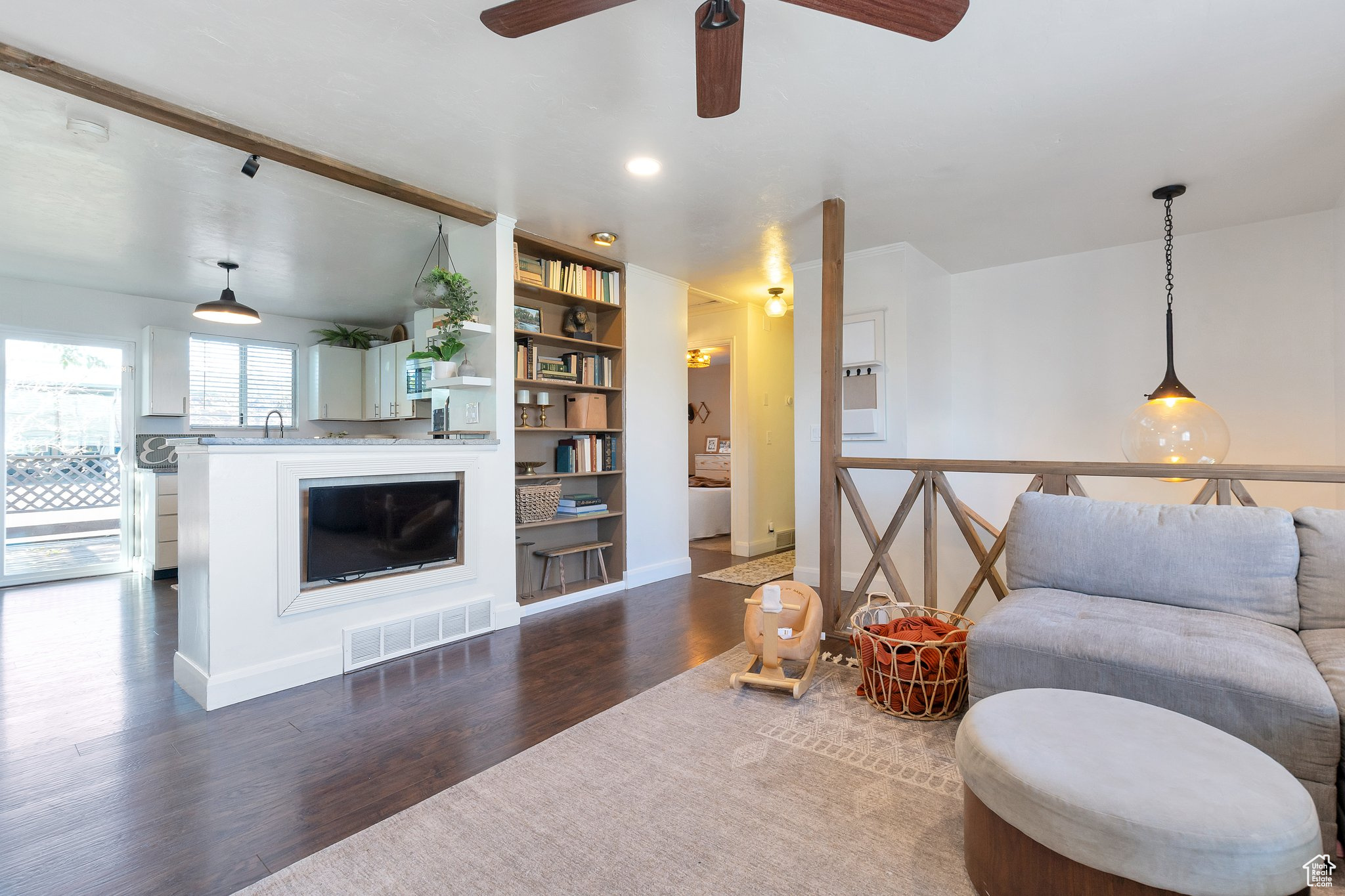 Living room featuring dark hardwood / wood-style flooring and ceiling fan