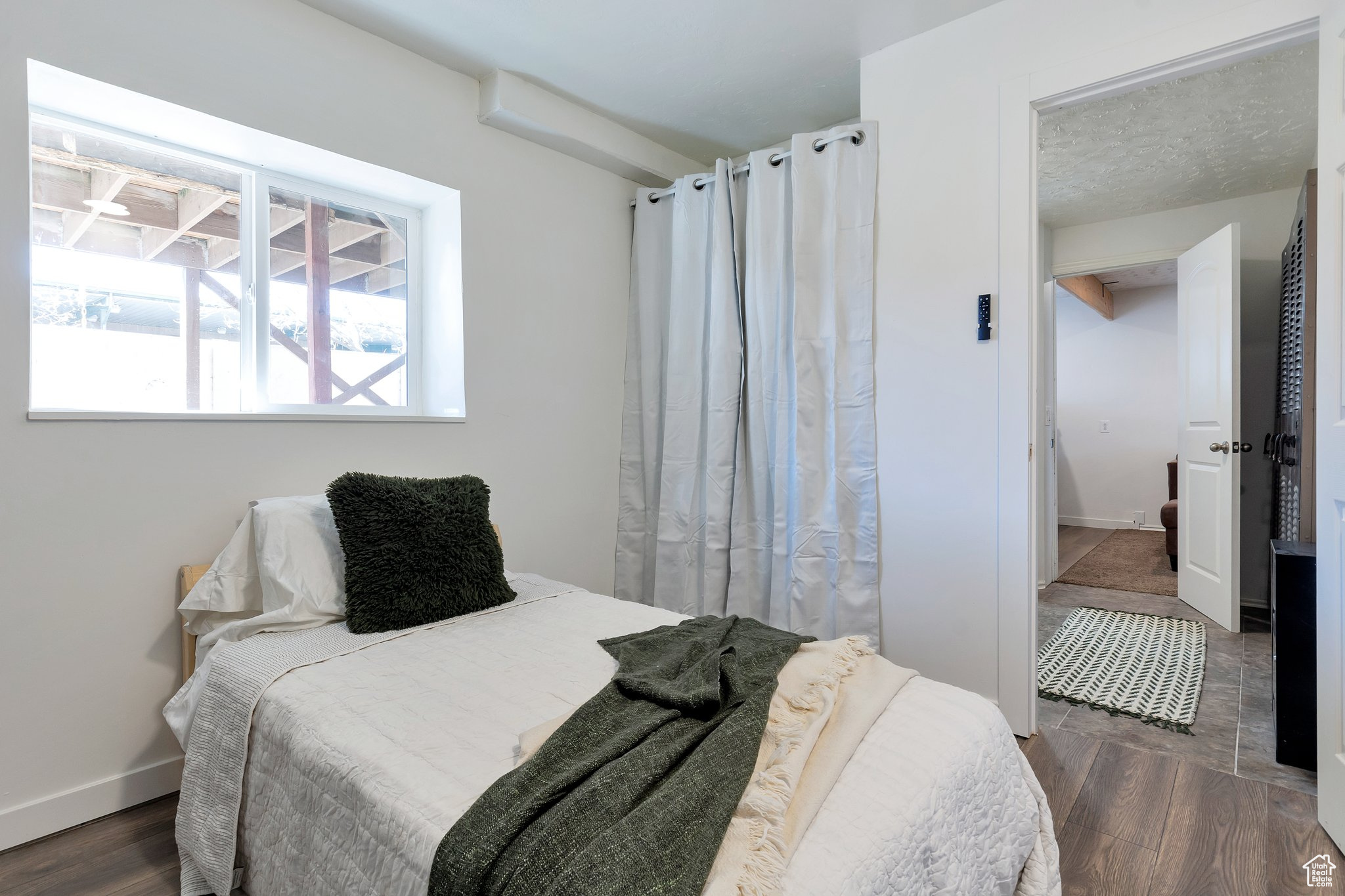 Bedroom with dark hardwood / wood-style floors