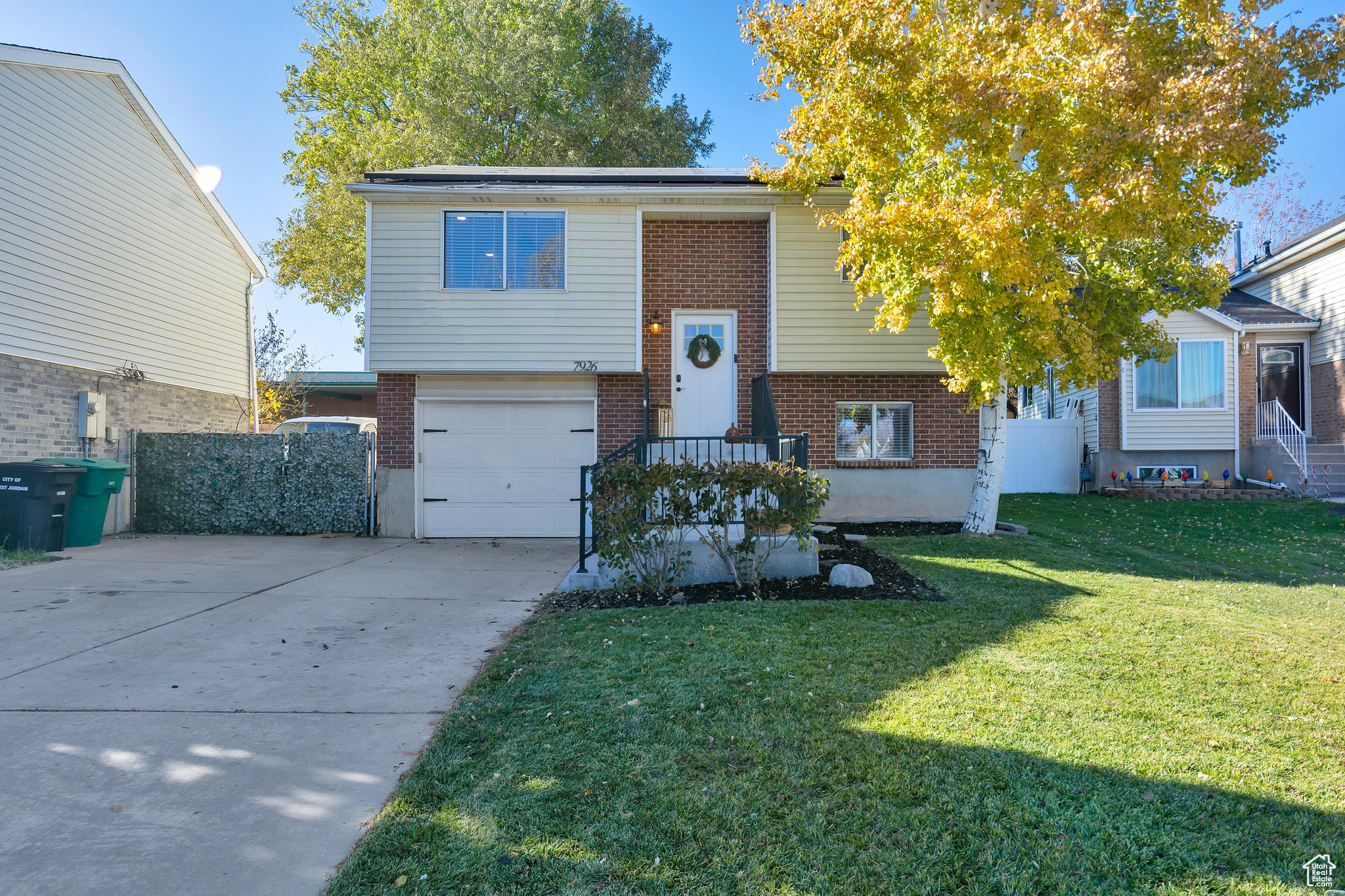 View of front of home featuring a garage and a front lawn