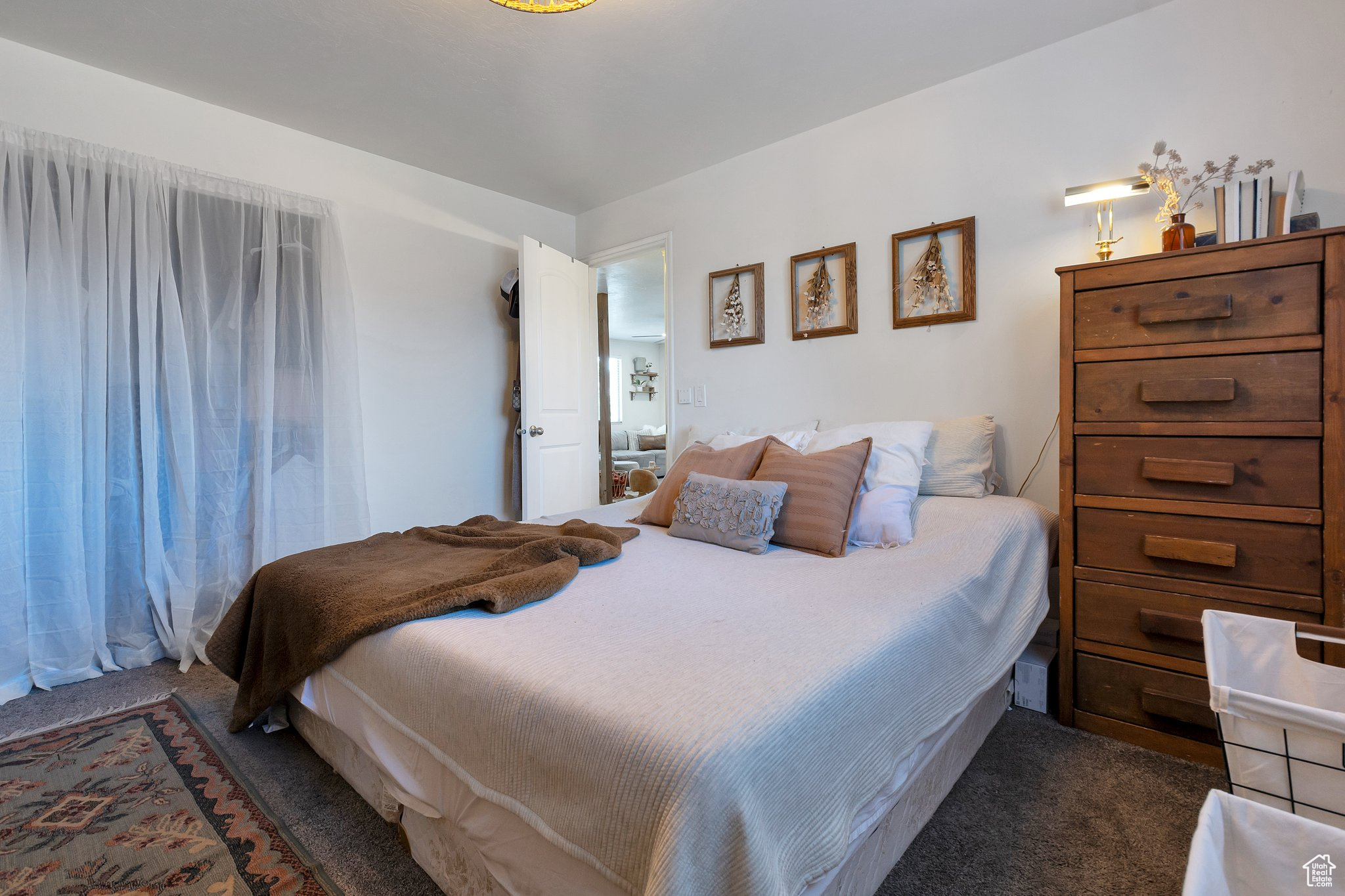 Bedroom featuring dark colored carpet