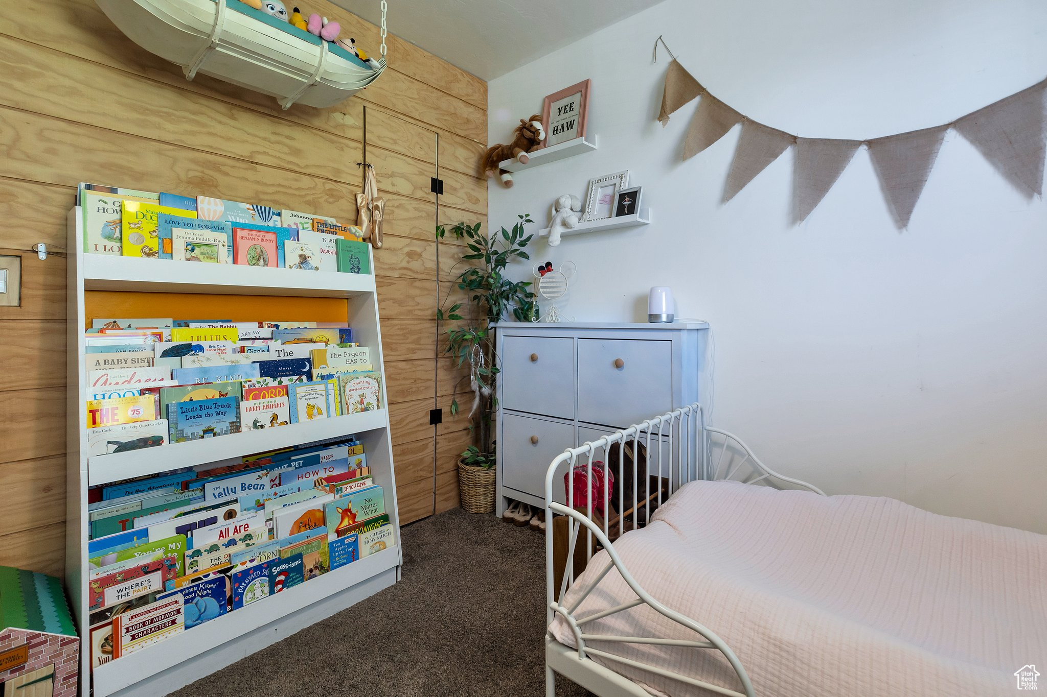 Carpeted bedroom with wood walls