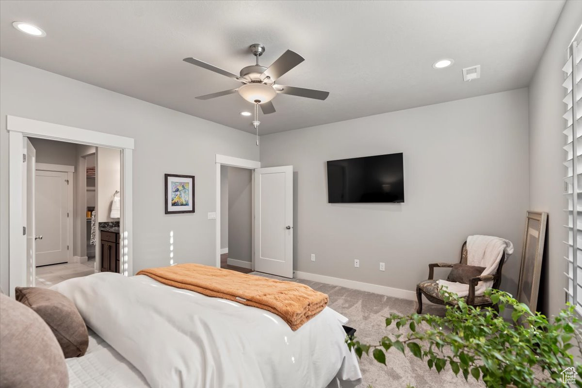 Carpeted bedroom with ceiling fan