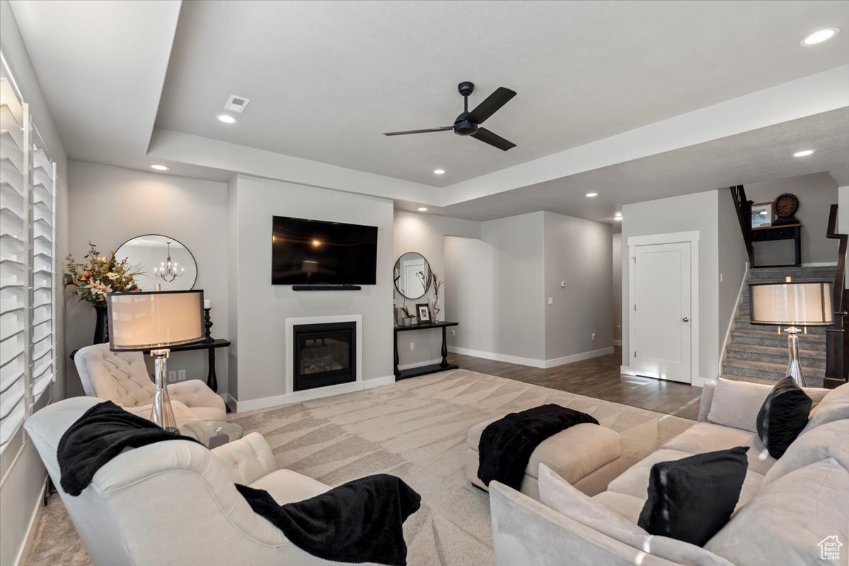 Living room featuring ceiling fan and light hardwood / wood-style floors