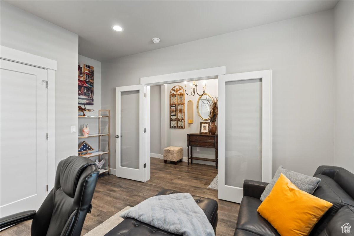 Office area with french doors and dark wood-type flooring