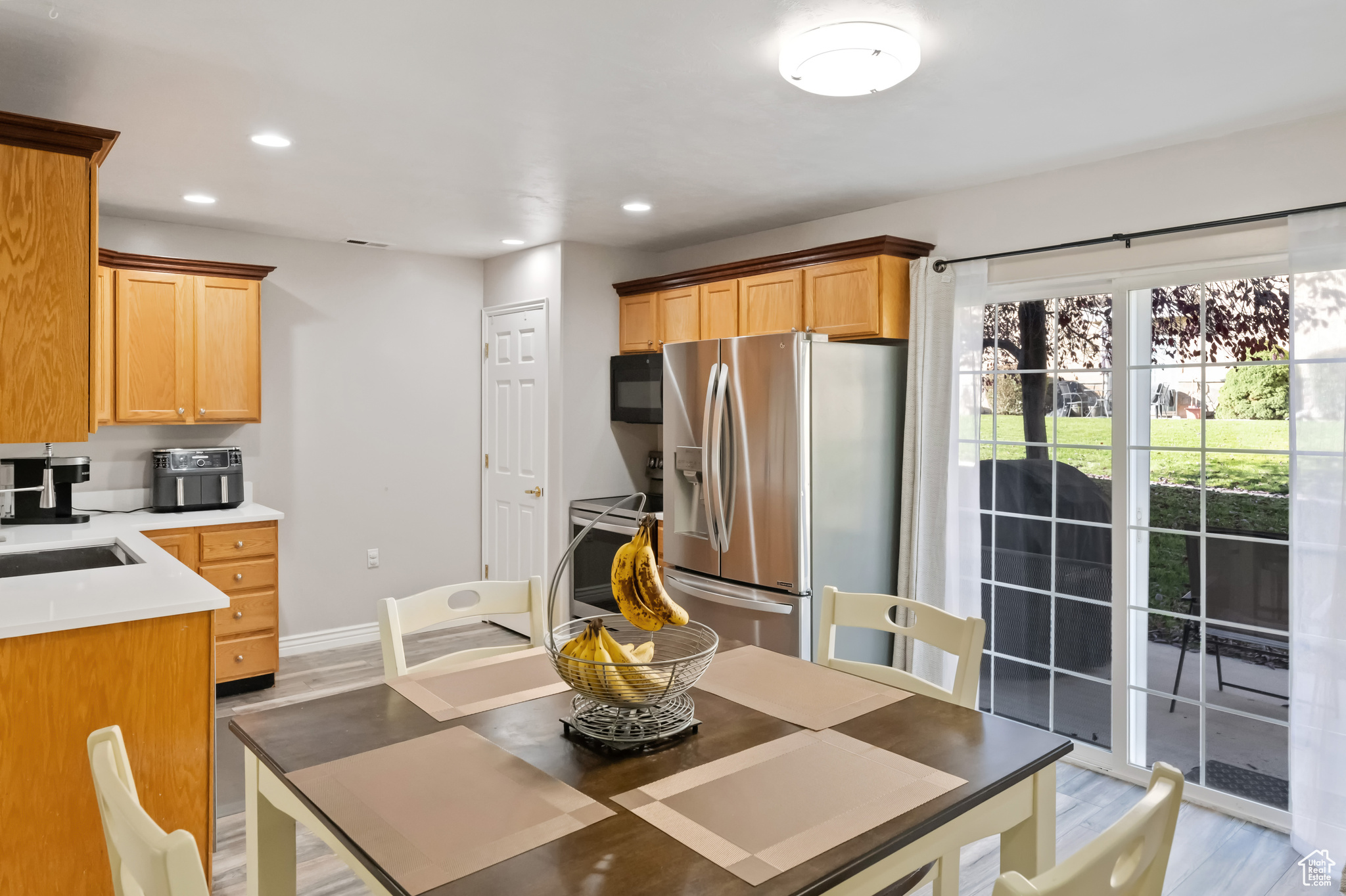 Kitchen featuring sink, light wood-type flooring, and appliances with stainless steel finishes