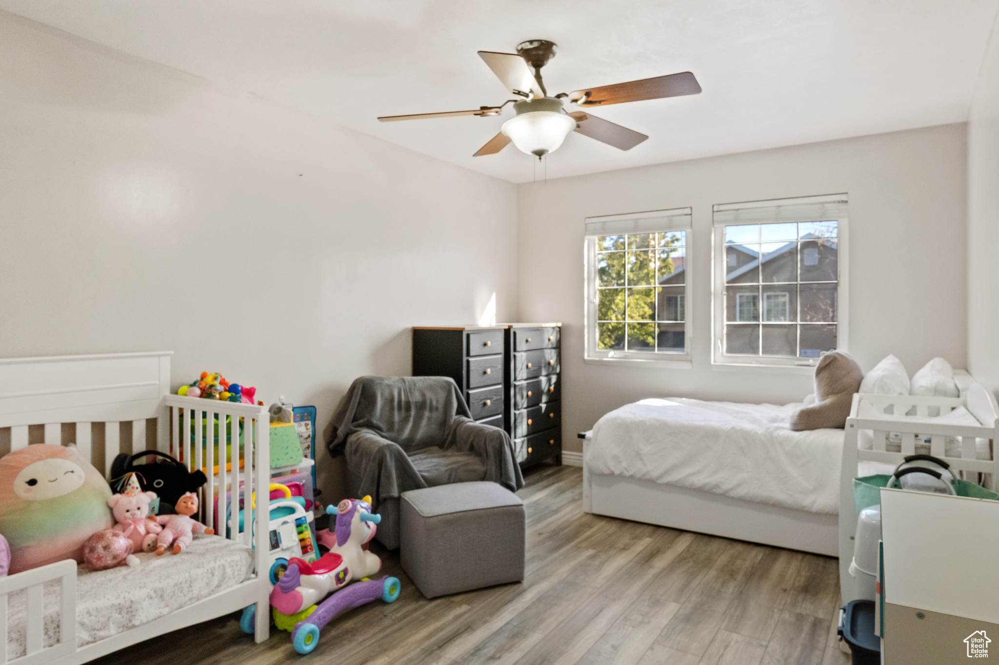 Bedroom with light hardwood / wood-style floors and ceiling fan