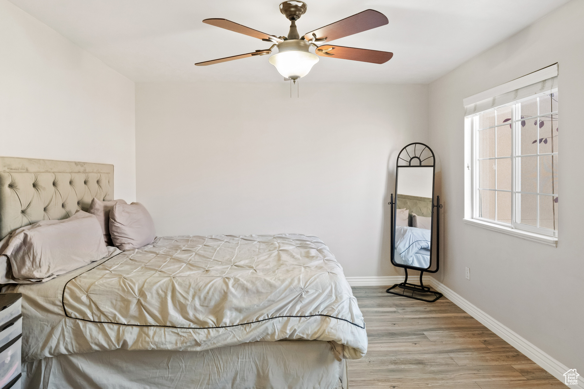 Bedroom with ceiling fan and light wood-type flooring